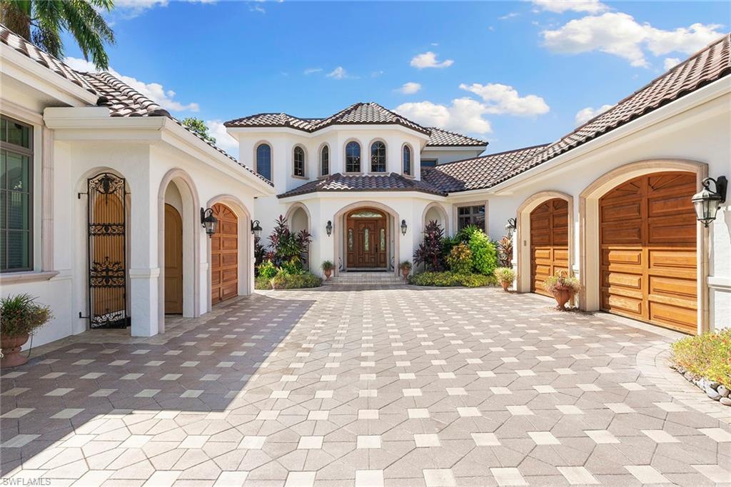 Tucked away on Palm Circle in Old Naples, this bright four-bedroom home plus studio sits on a half-acre lakefront lot and is just 3.5 blocks from the beach. Step through the doors of this classic two-story home into a light-filled foyer which leads to a covered lanai and summer kitchen. The backyard oasis with highly coveted Western views is complete with a shimmering pool and spa. The formal living room and dining room lead to an open great room and kitchen with panoramic views of South Lake. The first-floor primary suite features walk-in closets, a spacious bath and a private study. An additional guest room with en suite is on the first floor, while the second floor boasts two bedrooms with en suites offering stunning sunset views. The home features three garages, a separate studio entrance and is conveniently located just minutes from the highly anticipated new Four Seasons Beach Club and the shops and dining on Fifth Avenue and 3rd Street.