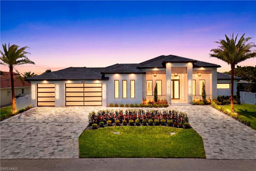 RARE TRIPLE-LOT MODERN ESTATE in the HEART of SW Cape Coral w/ 4,861 total sq ft, HIGH-END FINISHES, 45-ft RESORT POOL & OVERSIZED SPA, GRAND CIRCULAR DRIVEWAY & EXPANSIVE YARD w/ room for toys, watercraft or extra outdoor living. Bright & open layout w/ 72x41 SPANISH PORCELAIN TILE. SPACIOUS 252 sq ft FRONT PORCH w/ MARBLE columns, impact glass accents, wood ceiling & STRIKING CHANDELIERS. Step through 10-ft tinted Low-E impact DOUBLE DOORS into IMPRESSIVE FOYER. STRIKING ENTRYWAY w/ GOLDEN CHANDELIER & built-in FEATURE WALL CABINETRY w/ integrated LED ACCENT LIGHTING! Living room w/ 16-ft COVE CEILING, flat wood panels & beams, ITALIAN WALLPAPERED FEATURE WALL w/ cabinetry & LED-lit shelving, 85" TV & BOSE SURROUND SOUND SYSTEM. Modern GOURMET KITCHEN w/ PREMIUM CRAFTSMANSHIP, DACOR MODERNIST electric WALL OVEN w/ built-in MICROWAVE, INTEGRATED DISHWASHER & built-in SIDE-BY-SIDE REFRIGERATOR/FREEZER. Commercial-grade HOOD concealed in cabinetry. OVERSIZED CRISTALLO QUARTZITE WATERFALL ISLAND w/ SCULPTURAL ANGLED ENDS, ELEGANT WHITE & GOLD PENDANT LIGHTING & CABINETRY w/ under- & upper-cabinet lighting, QUARTZITE COUNTERTOPS, full-height backsplash, POT FILLER & large sink. BUTLER'S PANTRY w/ CRISTALLO countertop, glass-front cabinetry, built-in DACOR DUAL-ZONE WINE COOLER & FULGOR MILANO INTEGRATED COFFEE MACHINE. Walk-in full-shelf pantry. SOPHISTICATED FORMAL DINING w/ TRAY CEILING wood accents, STATEMENT LIGHTING, 2 oversized 8-ft picture windows & built-in buffet w/ extra cabinetry & serving space. FOUR PRIVATE PRIMARY SUITES, DEDICATED OFFICE & FULL POOL BATH - flexibility for luxury living, guests & multigenerational use. PRIMARY SUITE offers scale & privacy w/ its own A/C system. DUAL WALK-IN CLOSETS w/ illuminated display cabinetry & dedicated purse/display shelving. SPLENDID SPA PRIMARY BATH w/ FULL GLASS SHOWER ENCLOSURE w/ DUAL RAINFALL SHOWER, FOUR BODY JETS, handheld showerheads, FREESTANDING SOAKING TUB, floating vanities & DUAL EXTRA LINEN/TOWEL STORAGE TOWERS w/ glass-front LED-lit cabinetry. All bathrooms w/ CRISTALLO QUARTZITE countertops, extra-large vessel sink & WALL-MOUNTED SMART TOILETS w/ BIDET FEATURES & CONCEALED in-wall TANK SYSTEMS. All bedrooms w/ ELEGANT TRAY CEILINGS w/ WOOD INLAY ACCENTS. SPLIT FLOOR PLAN for privacy & convenience. OVERSIZED HEATED SALTWATER POOL & SPA, marble pavers w/ artificial turf inlays, lush landscaping, FULL PANORAMIC HIGH-SCREEN ENCLOSURE & fenced backyard. L-SHAPED OUTDOOR KITCHEN w/ BULL GRILL, side burner, COMMERCIAL HOOD, fridge, sink & storage & 553 sq ft COVERED PATIO w/ wood ceiling, fan, BOSE SURROUND SYSTEM, 75” TV & STORAGE ROOM. Laundry w/ LG WASHER & DRYER ON PEDESTALS, utility sink, backsplash, extra refrigerator/freezer, FOLDING COUNTER & storage. CIRCULAR DRIVEWAY w/ 3-CAR GARAGE (785 sq ft), impact doors, insulated ceiling & UTILITY SINK w/ SS tub. OFFERING OVERSIZED REFINED COASTAL LUXURY, this EXCEPTIONAL HOME is a RARE OPPORTUNITY TO ENJOY THE VERY BEST OF SWFL living!