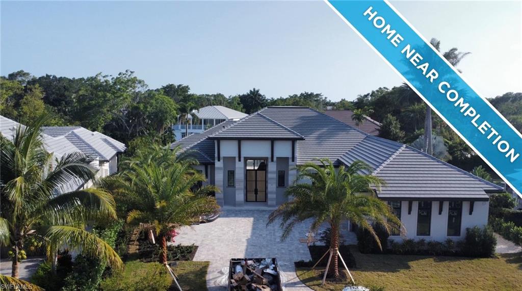 New construction, exceptional craftsmanship, soaring ceilings, and bespoke Ruffino cabinetry define this masterpiece built by the renowned Knauf-Koenig Group. Offered unfurnished, the expansive single-story layout features five bedrooms, plus a study, adorned with elegant details and premium finishes that truly distinguish themselves in terms of design and construction quality. A must-see benchmark in Floridian luxury living. This coastal new construction home with much-desired southern exposure is located in the heart of The Moorings on an oversized lot. Thoughtfully designed in collaboration with Calusa Bay Interiors, the home embodies relaxed elegance with an impressive chef’s kitchen, a butler’s pantry, glass-enclosed wine room. Tall sliding glass doors provide a seamless transition from the indoor to the outdoor living spaces, including an oversized pool & spa, and a large covered lanai with retractable screens, a summer kitchen, lounge area, fireplace & powder bath. The spacious owner’s suite features a morning bar, two walk-in closets, private laundry & a luxurious bath with a soaking tub & expansive shower. Perfectly located close to amenities, including Naples’ famous sugar sand beaches, 5th Avenue South & Third Street South. A must-see!