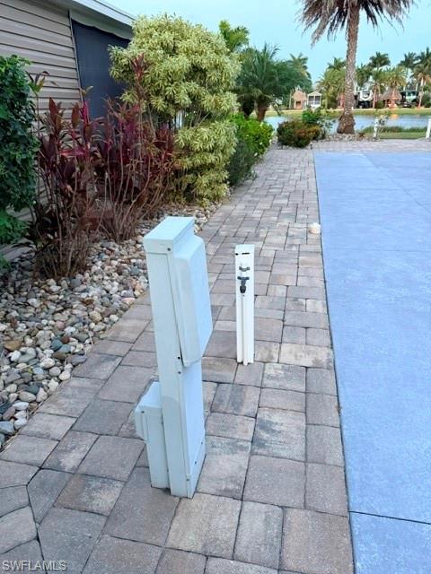 This east, facing Drive in motorhome lot sits on Sunset Lake and has a beautiful view of the lake and fountains.  The concrete has been faux finished with a diamond type sealer.  Extra pavers have been added for your additional comfort and lounging space.  Included on the lot is a 10 x 12‘ Amazon shed with a 10 x 24‘ extended roof with a sun blocking drop-down screen and a brand new entrance door for easier access.  Inside the Amazon shed features a full-size Frigidaire refrigerator freezer, a stackable Samsung full size washer and dryer which will save you many trips to the laundromat.  The floor is tiled and has a toilet, shower, an on-demand hot water heater, and a large stainless-steel sink that is built on a nice cabinet with a countertop.  Above the counter is overhead storage cabinets with a built-in GE microwave.  This lot is nicely landscaped It’s ready for your RV.