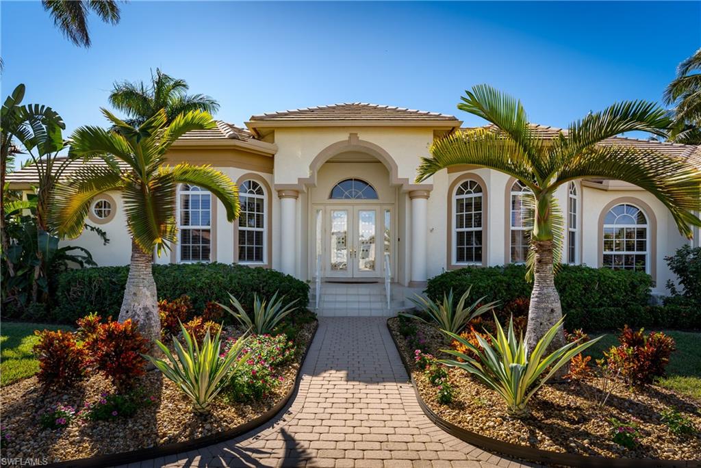 Fantastic opportunity to own a beautiful waterfront home with southern exposure located in the heart of Marco Island's exclusive Estates. This 4 Bedroom plus Den and 3 Bath home offers an over-sized 3 car, air-conditioned garage and large circular drive lined with Royal Palms. Custom designed and built by Divco, this immaculate home offers a spacious split floor plan, volume ceilings with custom moldings, a large gourmet kitchen featuring custom cabinetry, top of the line appliances with breakfast bar and center island. The great room opens to the lanai with zero-corner sliders for the ultimate indoor-out living! A large covered area with a wet bar and beverage refrigerator is perfect for entertaining family and guests. The spacious primary bedroom suite offers two oversized walk-in closets. The bathroom includes a walk-in shower and large jetted tub. Outdoor living at its finest... The large lanai includes a gorgeous pool and hot tub with expansive deck the entire length of the home and multiple seating areas. The private dock has 2 boat lifts with quick, deep water access to the Gulf of Mexico and 10,000 Islands of the Everglades. Enjoy the Marco Island lifestyle from this spectacular four bedroom home located on a half acre estate homesite with 125 feet on canal with quick direct access to the Gulf of Mexico. The private pool and deck offer year round sunshine, great fishing from your private dock. Make this home your Island paradise!