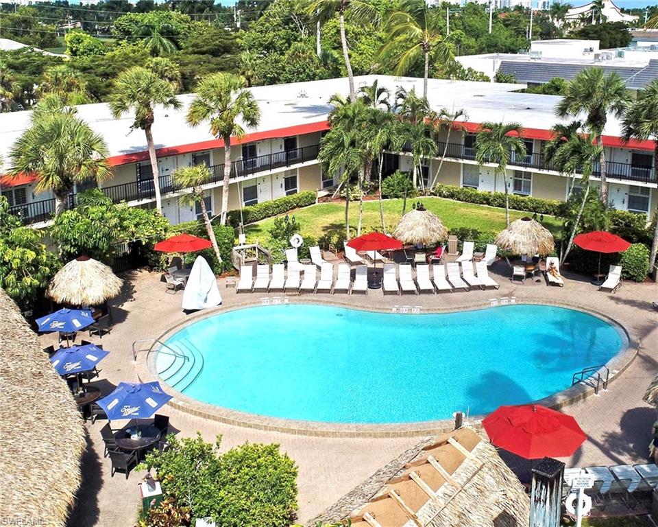 Resort Style Living in Paradise with Investment Income Opportunity makes this Unique Property at the Gulfcoast Inn Highly Desirable, at a bargain price in one of the most expensive cities in the United States! Ideally Centrally Located on Tamiami Trail, in the Upscale Moorings of Naples, just one mile from the World-Class white sandy Beaches of the Gulf of America and minutes from Old Naples shopping, dining, and entertainment. This 2nd floor studio/condo hotel unit is above hurricane flooding worries and offered turn-key furnished and ready for immediate occupancy or the rental program. The property provides exceptional flexibility with no minimum or maximum stay requirements, making it ideal as a personal getaway, long-term or short-term rental, seasonal residence, or additional accommodations for visiting friends and family. Owners may participate in the on-site rental program making money easy. Residents and guests enjoy Resort Style amenities including a large hotel pool with lounge chairs and umbrellas, tiki bar, daily continental breakfast, business center, social room, 24-hour security, on-site property management, and convenient free laundry and storage facilities plus free parking! In addition to Continental Breakfast and daily Coffee Bar in the hotel lobby and numerous ice and vending machines, there are Three On-site Restaurants include poolside fun, dining, and drinking at Harold’s Place, Vesuvio Pizza & Bar, and Fujiyama Hibachi Steak & Seafood. Monthly fees cover all utilities making ownership simple and cost-effective. PLUS NEW A/C, Refrigerator, and Microwave!