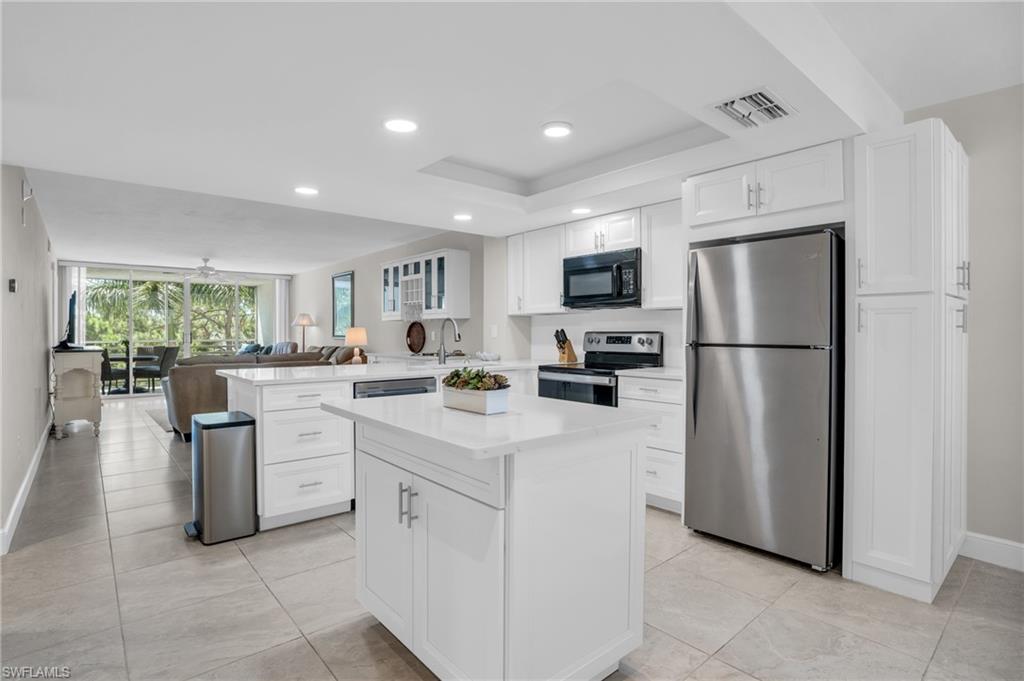 Prime location, renovated and turnkey furnished condo West of 41 in Naples!! Nothing to do but bring your clothes and start living your best Naples Lifestyle. This tastefully renovated 5th floor unit in Bay Forest’s Naples Cove features 2 bedrooms, 2 full bathrooms along with a laundry room. The remodeled kitchen is designed for open-concept living, featuring white cabinetry with detailed storage, stainless steel appliances, and quartz countertops leading into the wine bar and main living area for everyday enjoyment and entertaining. The private screened in lanai off of the living room has a southwest facing view of the peaceful preserve and the breathtaking sunset sky perfect for al fresco dining and relaxing in the Florida sun. The primary bedroom has a king size bedroom set, large walk-in closet and an en suite bathroom that has been fully remodeled with a stand up shower, glass doors and updated vanity overlooking the preserve. The secondary bedroom in the front of the unit also has a king size bedroom set and shares the renovated hall bath with a tub/shower combo and new vanity and mirror. Turnkey with well appointed furnishings, sheets, towels, and kitchen appliances. There is also a private storage unit by the elevator for beach chairs, bicycles and anything else you may need! Bay Forest is known for its relaxed pace of life and boasts an array of amenities, including an expansive bike and jogging path, bocce court, community clubhouse with pool/spa, fishing pier, and pickleball and tennis courts. Don’t miss an opportunity to own a piece of paradise in this sought-after community. Experience Naples living.. Call today!