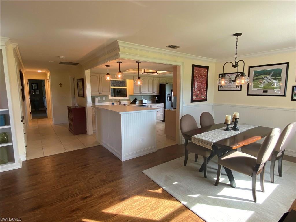 A classy masterpiece! 2 BR/2 BA/2 CAR Garage villa in Whiskey Creek Village Green. Bright kitchen offers: Beige kitchen cabinets; Corian countertops; new Slate fridge, stove, microwave and dishwasher 2018; breakfast nook; & an island for additional dining area. Living room, dining, and enclosed lanai with beautiful wood flooring. Carpet in bedrooms-tile in other areas. Living room with built-in bookcase & movable/removable knee wall separating enclosed lanai space-offering additional living space under air. Dining area with stylish white wainscoting panels to match panels on kitchen island and removable wall.  Spacious master bedroom. Relaxing spa-like master bath with natural stone tile floors, QUARTZ countertop, dual sinks, TRAVERTINE shower walls with FRAMELESS GLASS shower door, & MOEN fixtures. Soothing wall colors throughout every room. NEW Solid core interior doors, 5” baseboards and crown molding throughout. IMPACT WINDOWS (except lanai). TRANE AC 2017. PAVER DRIVEWAYS PLANNED for all homes in this section. 4 homes p/yr are selected by lottery. Section 8: 55+ COMMUNITY; low $310 monthly condo fee - ROOFS COVERED in fee; NO RENTALS; 1 pet under 20#. Beautiful community pool.