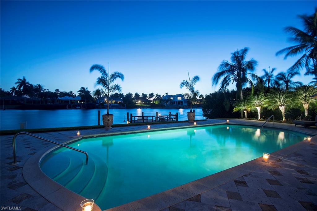 Situated on approximately 110 feet of water frontage framing scenic views of one of the widest points on Runaway Bay, this uniquely gracious property is truly one of the best values in Port Royal. Elegantly set back on the exclusive tree-lined Galleon Drive, the inviting exterior exhibits custom faux painting, Timberlane shutters, Dade County impact-grade Pella windows and doors, copper gutters, rich mahogany garage door and a sleek slate roof. Upon entry, one will delight in the quality of finishes that continue within, including chiseled-edge limestone flooring, extensively detailed hand-carved wood cabinetry and woodwork by Xavier collections, and countless one-of-kind details to complete the design. Homeowners are immediately eligible for Port Royal Club membership, making this property an ideal Naples beach oasis.
