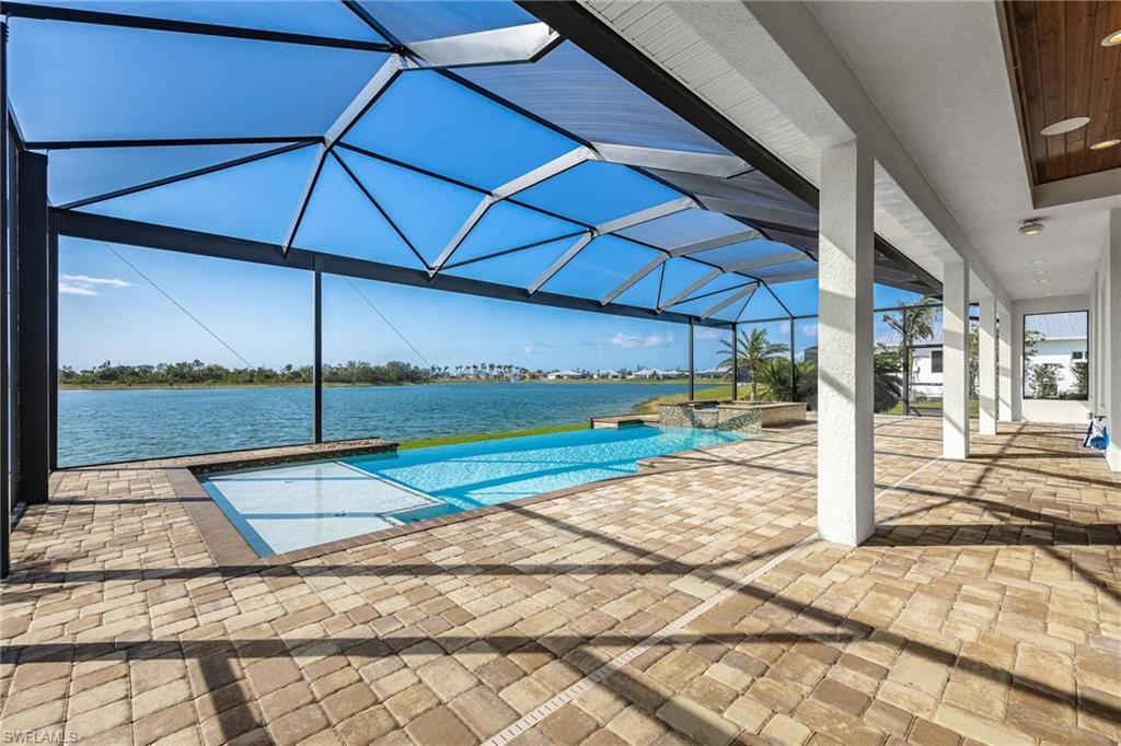 *LOWEST PRICED CUSTOM HOME IN KISMET LAKES!* One of the BEST lake VIEWS with HALF ACRE lots & low HOA fees. This beautiful home has UPGRADES GALORE and is sure to impress. Any chef would love the gourmet kitchen with SUB ZERO refrigerator, THERMADOR GAS RANGE, double wall oven/steam, & CAMBRIA quartz. Enjoy the ambiance of an electric fireplace, and accent lighting. Guest rooms share a Jack & Jill bath & all 3 baths offer CAMBRIA QUARTZ. Spacious Lanai features a SYNERGY WOOD ceiling & FOCAL built in speakers, outside and inside. SALT WATER POOL has a VANISHING EDGE for breathtaking views, a SUN SHELF & spill over SPA. Pent Air Intella pool system & hard wired SMART HOME with NVR. Some of the many upgrades include an OVERSIZED GARAGE, NEW TRANE 4 ton A/C with warranty, whole house generator and R/O system, 5 (wired for 8) outdoor cameras, wood closet shelving, Qmotion automated window coverings, sound proof walls, Lutron lighting, Electrolux central vac, XLG picture windows & PGT impact windows/doors. Upgrade list available. KISMET LAKES is PEACEFUL & UNIQUE with 28 ESTATE HOMES, Two Lakes, Streetlights, UNDERGROUND Utility and FIBER OPTIC CABLE.