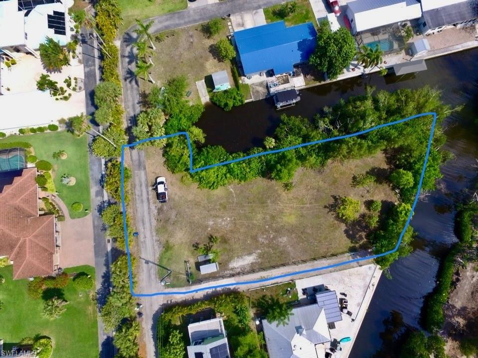 Imagine having a HALF ACRE building lot with 350 linear Feet of water frontage… just 50 feet from the Caloosahatchee River.  It is Mere minutes to open water from your intersecting canal.  This Penisula shaped property feels like you are secluded, yet in an established, private neighborhood. The lot has been cleared.  Two lots were strapped together as one, but could easily become 2 addresses again.  Convenient to everything yet located at the end of a Private, Quiet Road, there is no through traffic.  This could be the ideal spot to build your dream home or multi-family home and have plenty of land to grow.  NO HOA, County taxes only.