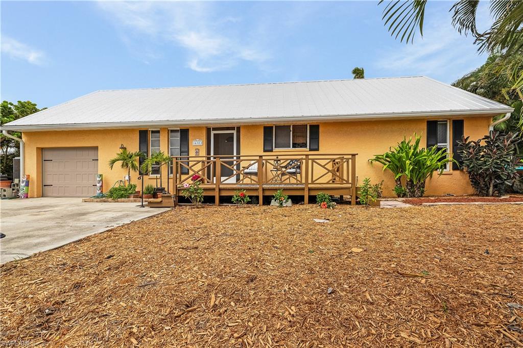 CHECK THIS HOUSE OUT TODAY!! 2 bedroom, 2 bath gulf access home with 80' of waterfrontage in beautiful Bokeelia. House is approximately 9' above sea level... NO FLOODING! The entire back of house is a screen enclosed lanai for fabulous entertaining space and then you step outside to a huge wooden deck with a built-in fire pit. The outdoor living possibilities of this home are endless. Boat dock with water, electricity and boat lift. Combination of hurricane shutters and windows. Maintenance free yard and the attic is a finished storage area. MAKE THIS HOME YOURS TODAY!!
