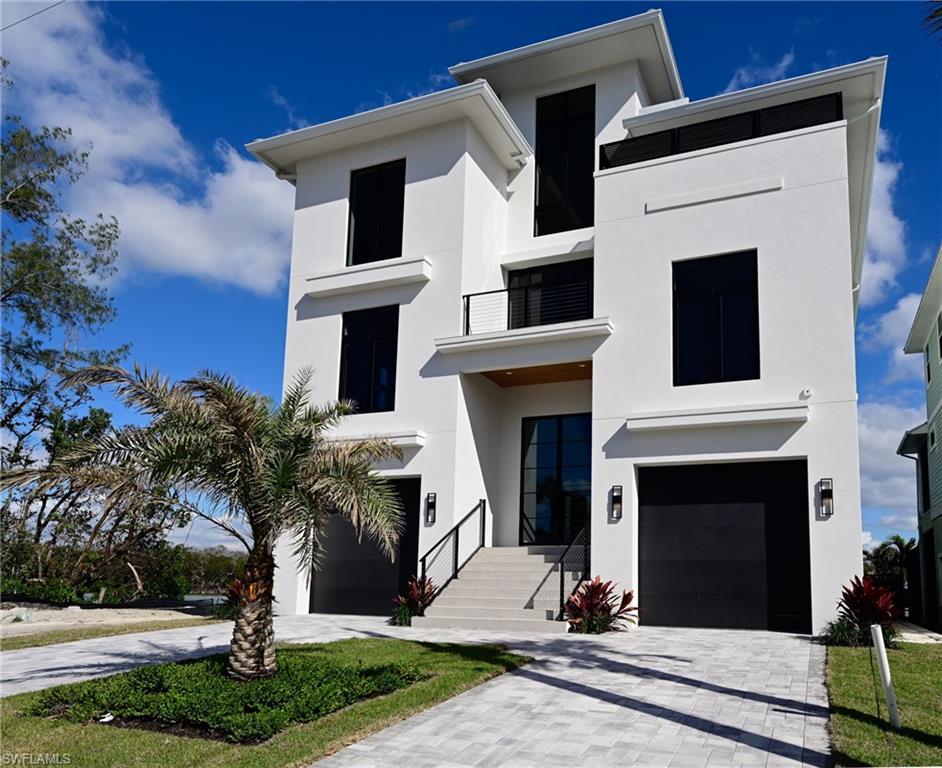 This coastal contemporary 3 story Bonita Beach bay front home offers it all for the best of the Florida lifestyle living including: situated on a quiet street on the bay with water views everywhere east north and south plus partial gulf views, it is located close to the Gulf of Mexico pass which brings the beautiful turquoise water to the bay waters behind your home, there is a Beach access across the street, premier boating from your property to the gulf in a few minutes (a Seller credit toward your boat dock will be given at closing), a tropical swimming pool and spa right on the bay with large entertaining deck, this RG Designs home was professionally decorated with high quality selections and furnishings throughout, four bedrooms all with on suite baths, the large master suite offers wide bay views and a private balcony, the open floor plan has been designed for maximum water views everywhere including large contemporary kitchen with island dining and great room features a wall of glass and open to a covered lanai with well equipped summer kitchen and direct access to the pool, plus a den/office, large powder bath, two large garages and a private elevator. The contemporary dream home is move in ready for a quick close for your enjoyment this season.