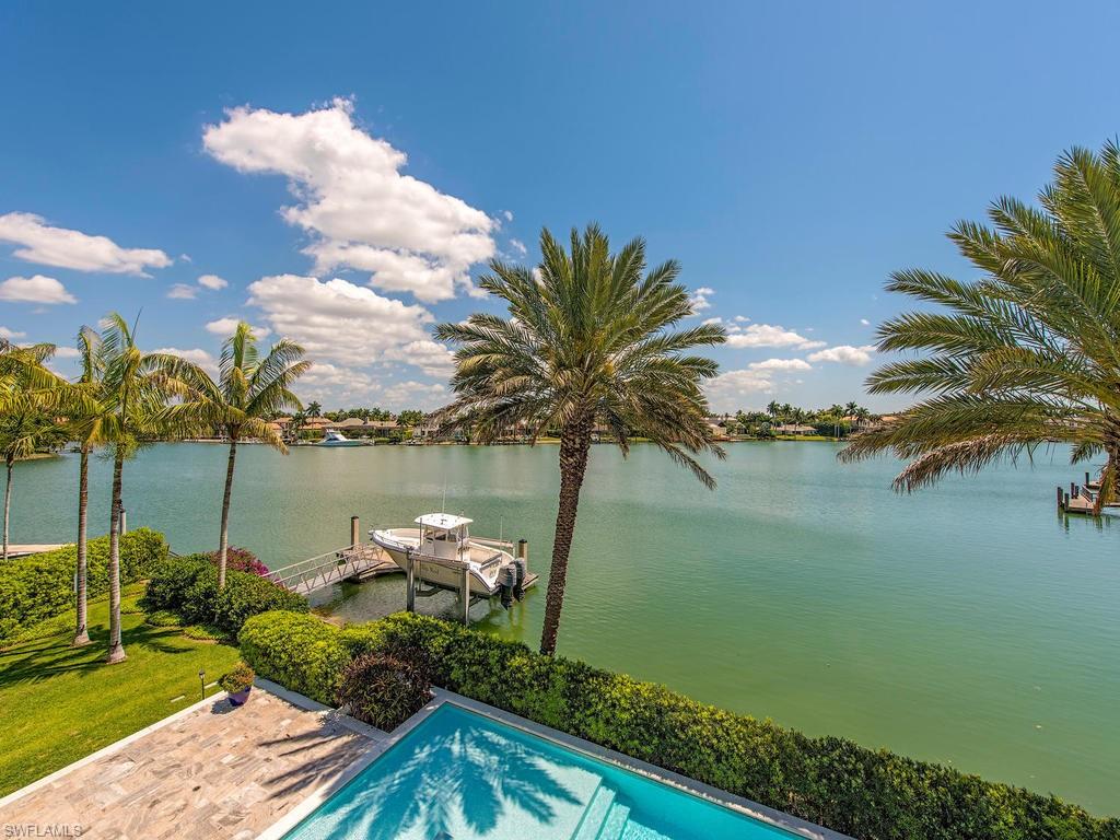 H.14459 - Long, wide water views w/direct Gulf access! Top quality, built in 2009 by BCB, well designed, sophisticated & spacious 7,219 sq. ft. open floor plan! Thoughtfully created to capture expansive water views of Man O' War Cove. Unique floor plan w/5 bedrooms, 5 full baths & 2 half baths with maximum bay views from all the main living areas and bedrooms. Featuring a gourmet kitchen with Wolf gas range, double ovens, Sub-Zero fridge and a grand sized granite topped island, walk-in pantry plus a caterer's pantry and wine room. Luxurious first floor master suite boasts a morning kitchen, 2 walk-in closets, his/her water closets, soaking tub and spacious shower. Beautiful wood & marble flooring; Elevator; Separate 1 BR guest/nanny/in-law suite w/ living room & private entrance. Ideal for entertaining with expansive lanai, summer kitchen, pool bath and fireplace all overlooking gorgeous water vistas and a 50’ floating dock. Just minutes from Third Street and Fifth Avenue South world-class restaurants, boutiques, galleries and cultural events. This property offers eligibility for a Primary Membership to the exclusive Port Royal Club.