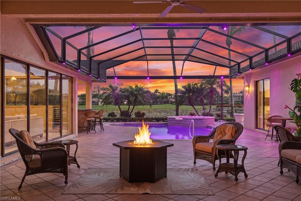 Designed around a spectacular central pool and spa, this spacious three-bedroom-plus-den residence offers an exceptional floor plan that embraces the Southwest Florida lifestyle. Sliding glass doors span the main living area, creating a seamless connection between the home and the generous outdoor living space. The living room, family room, and primary suite each open directly to the lanai, where a heated pool and spa, outdoor kitchen, bar, and entertainment area provide an impressive setting for relaxing and entertaining against beautiful lake and sunset views.

Inside, the kitchen features granite countertops, stainless steel appliances, extensive warm wood cabinetry, and a large walk-in pantry. The private primary suite includes two custom walk-in closets, electric shades, lanai access, and a spacious bath with dual vanities, a walk-in shower, and a jetted soaking tub. Two guest suites are thoughtfully located on the opposite side of the home for privacy. A whole-home Sonos audio system, poolside speakers, built-in cabinetry, a wine refrigerator, and abundant storage add comfort and convenience throughout.

Recent improvements include a new pool cage and LED pool lighting in 2025, luxury vinyl flooring in all bedrooms, rear landscaping, an epoxy garage floor, and more. Offering wonderful scale, architectural warmth, and tremendous potential for personalization, this distinctive home is located within the exceptional, amenity-rich Palmira Golf & Country Club community.  Step inside and discover a home whose exceptional design, captivating setting, and possibilities are best appreciated in person.