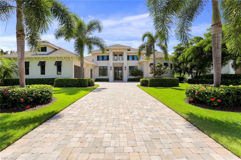 Perfection in design, floorplan, and elegance, this single-story,  4 BR | 4.5 BA | 3 CG | Home Office| Pool-Spa | Laundry Room | Coffee Room and Exceptional Lanai is situated in the heart of Naples most sought after community, The Moorings. No detail was spared in this newer construction home, from the wide oak plank flooring, spacious gourmet kitchen, privately landscaped pool area and pristine epoxied three car garage. Perfect for entertaining or hosting family, this spacious open floor plan coupled with soaring ceilings offers over 4,000 square feet and split bedrooms all including en suite bathrooms providing private space for all guests. Subzero and Wolf appliances, luxury custom electric blinds, outdoor covered kitchen and modern pool and hot hub are just a few of the benefits this home offers. Minutes from the beach and Naples premier shopping and downtown, this home truly provides the ultimate Naples Lifestyle. With over $100,000 in upgrades since 2017, this home will not last long! Upgrade list attached to MLS.