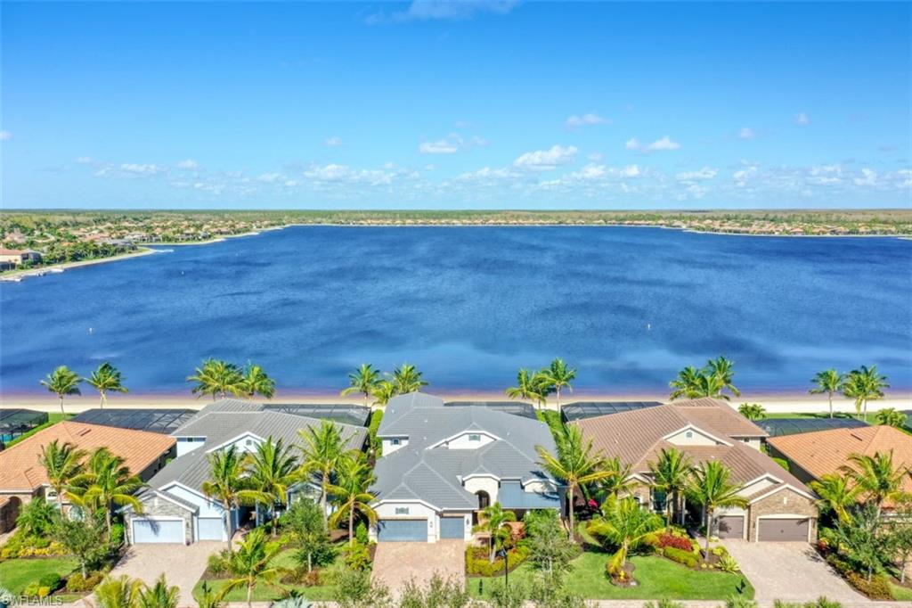 A RARE FIND! This mint condition 5 Bedroom+Den+Loft, 5.5 Bath home is situated within a gated enclave of only 14 homes along the sandy beach with a mile long view of Stone Lake! Built in 2017, this custom home offers the best of the best including: expanded 30'x30' three car garage; Thermador appliances: GAS cooktop & double wall ovens; hurricane impact windows/doors & electric roll down shutters on the lanai; outdoor kitchen; 43' long GAS heated, salt water pool with raised spa & sunshelf with travertine marble deck; cypress wood lanai ceilings; 10' zero edge sliding glass doors to the lanai; 13' ceilings; extensive moldings & trim; 8" baseboards; solid core doors; wood look tile floors throughout; deeded boat slip; central vac; & more! The Quarry is a lakefront community offering something for everyone: Boating, Golf, Tennis, Pickleball, Bocce Ball, Tiki Bar, Restaurant, Pool-Side Food/Drink Service, Gym, Social Activities including Full Time Social Director, and more! The Quarry offers a lifestyle like no other, including an impressive "Lake Lodge" ($18M renovation to be completed June 2023) and over 500 acres of navigable lakes and a private 18 hole Golf Club (Not Mandatory).
