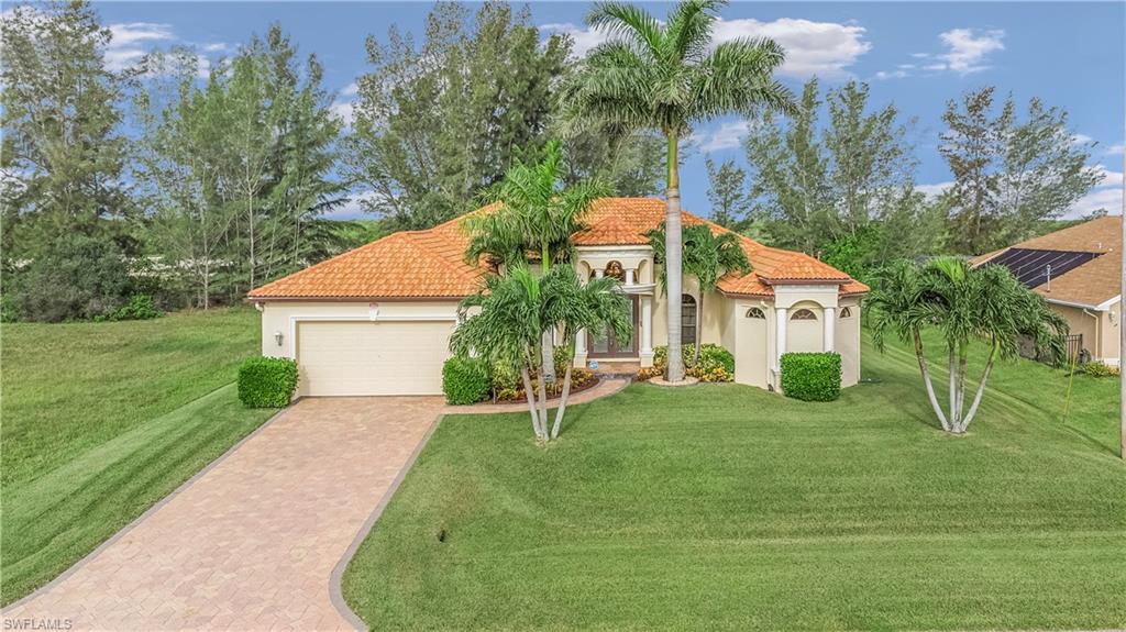 Welcome to our beautiful Mediterranean style home in NW Cape Coral.  If you are looking for a home in pristine condition, ready to move in and full of all the features and benefits of a Florida life style . . . Stop Here!!!  Tiled roof, paver driveway and lanai, 5 Kw electric system installed in 2018 to substantially cut your electric bills is just the beginning.  Built-in entertainment center, double door entry, 12 and 14 foot ceilings, granite counters, 42" solid wood cabinets and all stainless appliances.  If that is not enough, try the large salt water pool, 60 foot long paver deck, with fully enclosed 140 mph rated screen-in cage.  Master offers tray ceilings, Jacuzzi tub, His and Hers vanities and walk-in closets.  Home has full outdoor surveillance cameras and security system.  We are loaded with features too numerous to mention!  Make that appointment today and see for yourself the wonderful price / value this property will bring to you.  Florida living at its best in the very popular NW portion of Cape Coral, you will not be disappointed!