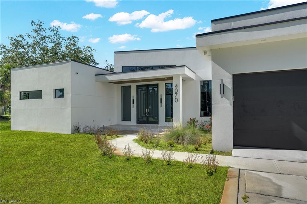 Luxury New Construction Estate on 2.73 Acres in Golden Gate Estates!

Experience the perfect blend of modern luxury, exceptional craftsmanship, and privacy with this stunning custom-built estate situated on 2.73 acres in one of Naples' most sought-after areas. Designed for both elegance and functionality, this brand-new residence offers 4 spacious bedrooms, 4.5 bathrooms, and a thoughtfully designed open-concept split floor plan that maximizes comfort and privacy.

Step into the impressive great room featuring soaring 14-foot ceilings and an abundance of natural light, creating a bright and inviting atmosphere. At the heart of the home is a spectacular Italian-designed chef’s kitchen, complete with premium panel-ready appliances, custom cabinetry, and a sleek contemporary design that seamlessly blends style and functionality.

Built with quality and durability in mind, this home features solid wood interior doors, high-impact hurricane-resistant windows and doors, two central HVAC systems, a state-of-the-art whole-house water filtration system, and a security surveillance system already installed for added peace of mind. The raised reinforced concrete stem-wall foundation provides enhanced structural integrity beyond a traditional slab construction.

The exterior is equally impressive, showcasing a modern flat roof design with parapet protection, a spacious two-car garage with an epoxy-finished floor, and expansive acreage offering endless possibilities for a guest house, workshop, pool, outdoor entertaining area, or simply enjoying the privacy and beauty of Golden Gate Estates.

Survey, elevation certificate, and complete building plans are available for review. This exceptional property offers a rare opportunity to own a truly custom luxury estate with premium finishes, innovative design, and acreage to enjoy the Naples lifestyle without HOA restrictions.

New Construction • 2.73 Acres • 4 Bedrooms + 4.5 Baths • Luxury Finishes • Impact Windows & Doors • No HOA

Don't miss your chance to own this one-of-a-kind estate—schedule your private showing today!