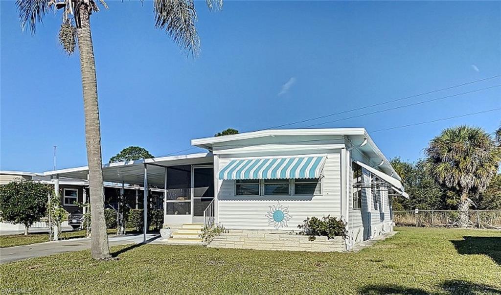 Nicely renovated home in the great community of Carriage Village. It has a totally new tiled bathroom, new kitchen counter, double bowl stainless steel sink, and faucet,  new water heater, lots of  new plumbing, new bamboo floors in kitchen, living area, and hallway. Freshly painted inside and out. Home is furnished and the second small bedroom was turned into an indoor laundry room. It has a huge screened lanai which could easily be closed in for extra living space -- den, another bedroom? Room for both! This home is located at the back of the community and has a large yard which backs up to a nature preserve. The community is pet friendly and you are allowed to erect a "see-through" fence, like a picket fence or chain link fence. Carriage Village is a great place to live -- whether you'll be a winter resident or live here year round. There is a beautiful clubhouse and swimming pool, lots of activities and friendly neighbors, it's well cared for, and monthly fees are only $77 per month!