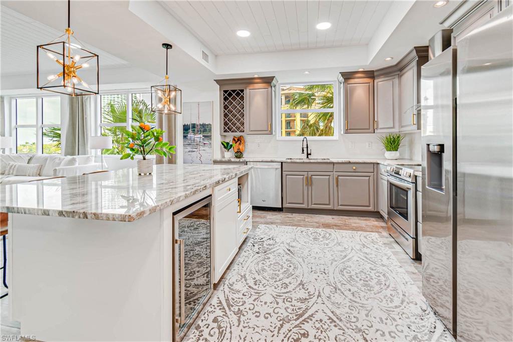 Wow! Completely remodeled & FURNISHED condo in a luxury high-rise with incredible river views! Step through the front door & fall in love with the bright & open layout, with views of the water all around you. Upgrades include new plank tile flooring throughout, re-designed kitchen layout with large island, granite counter-tops, new stainless steel appliances, tile backsplash, custom woodwork including shiplap in the tray ceilings, and a fireplace in the living room! The master retreat has sliding doors to the screened-in balcony, allowing you to enjoy the views from bed! The master bathroom has a new vanity with dual sinks and a stunning shower with frameless glass door. You have two additional guest rooms with a Jack and Jill bathroom, and a third full bath. As if that wasn't enough, there is a private den with sliding pocket doors and it's own separate balcony, easily converted into a fourth bedroom! Located in the Beau Rivage in downtown Fort Myers, it is convenient to shops, restaurants, and entertainment! Community amenities include pool, spa, tennis, pickleball, fitness center, a community gathering room, and guest suite available on a first come first serve basis.