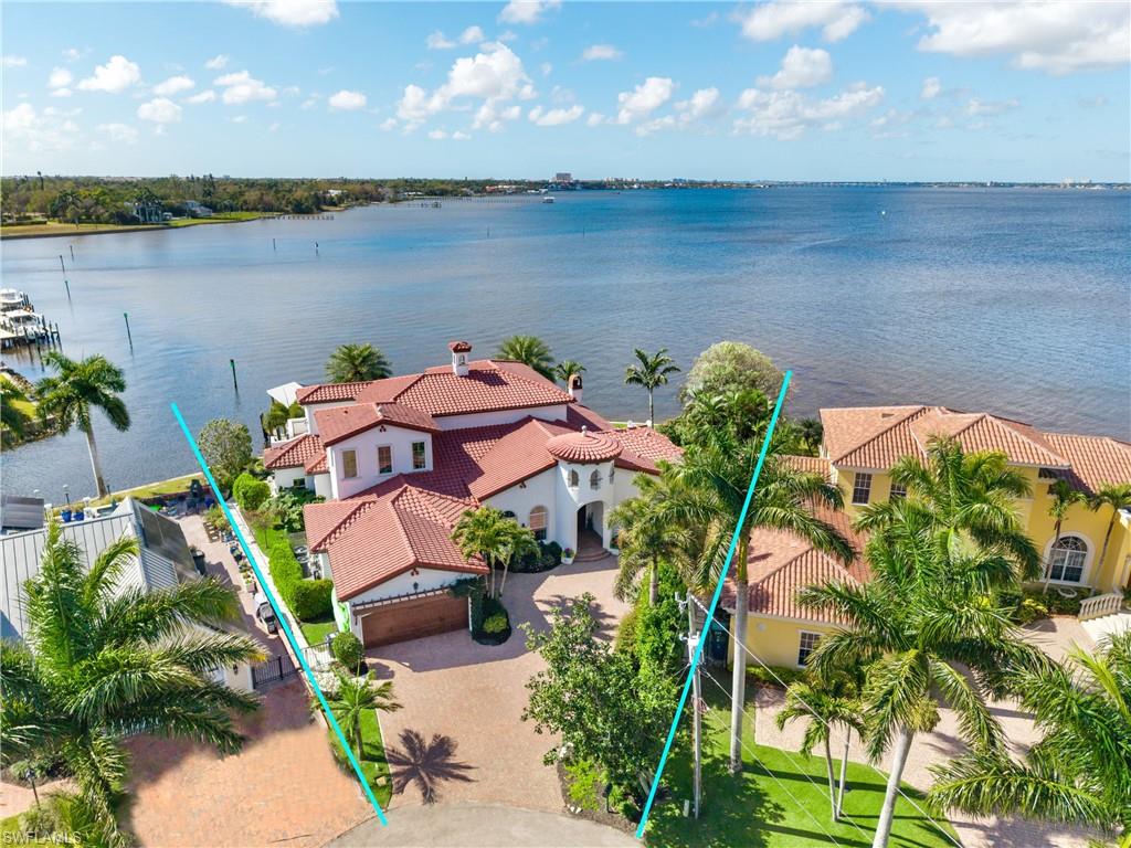 From the moment you enter, natural light and sweeping river views set the tone for this exceptional waterfront home, perfectly positioned on a rare curved lot that maximizes panoramic water vistas from nearly every room. Built in 2016 and offering over 5,100 square feet of elevated living space, the residence combines thoughtful design, quality construction, and effortless indoor-outdoor living. Inside, distressed hickory flooring adds warmth and character throughout the open-concept floor plan. The main living areas are intentionally oriented toward the river, creating a seamless connection to the surrounding waterfront scenery. The chef’s kitchen serves as the heart of the home, featuring double islands, distinctive walnut cabinetry with a live-edge design, and generous space for both entertaining and everyday living. The home offers four bedrooms, a dedicated den, and a large bonus room ideal for a media room, office, fitness space, or additional guest accommodations, along with four and a half bathrooms for comfort and privacy. Additional features include impact windows, Storm Smart screens, three recently replaced state-of-the-art A/C systems, and a Kinetico whole-home water filtration system. Outdoor living is equally impressive with southern exposure providing beautiful natural light and cooling summer breezes. The expansive deck surrounds a pool and spa and includes an outdoor shower, all designed to capture the tranquil river setting. Boating enthusiasts will appreciate the deep-water access with quick routes to both the Gulf and Bay waters. The property is fully equipped with a covered boathouse, 7,500-pound lift, and solid seawall. Ideally located just off historic McGregor Boulevard, the home offers convenient access to downtown Fort Myers, dining, parks,schools and everyday amenities—an exceptional opportunity to experience refined waterfront living.