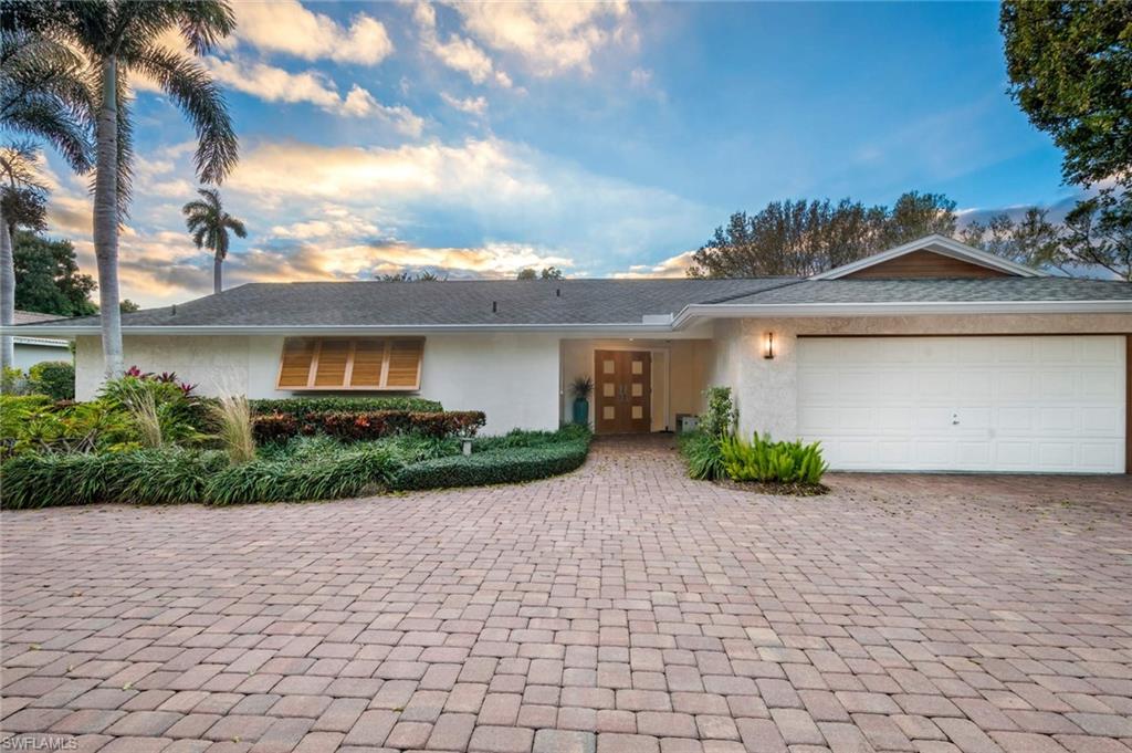 A Vintage Naples Home, located on one of The Moorings most desirable streets, evolved to a mid-century/art deco interior by renowned craftsman. Large corner lot with well-groomed mature landscape and paver driveways with parking for 8 cars. Interior remodeling opened the floor plan of this 4 bedroom, 2 ½ baths. Kitchen features SubZero, Wolf, and Miele appliances. The island features a live edge American Black Walnut bar harvested from FDR's Hyde Park Estate in the 1950's. Exquisite custom wood built-in bar and powder room and interior doors. Limestone floors, custom lighting and speaker system enhance this home. The exterior is also well featured with Dominican Coral Stone exterior cladding details and Solid Quartered Oak entry doors, impact sliders, Quartered Oak Summer Kitchen and exterior details. Located in the heart of The Moorings equally convenient to Waterside Shops, Venetian Village and Fifth Avenue S/Third Street. Eligible for private Moorings Beach Club membership for $100 per year.