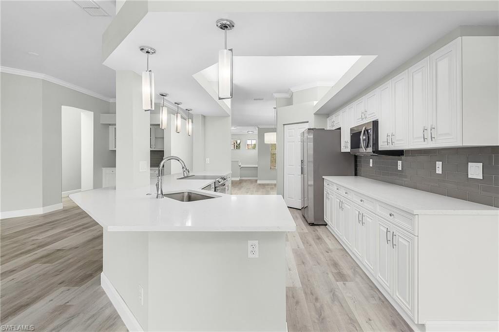Absolutely stunning water view from this beautifully renovated 3 bedroom, 2 bath condo with a 2 car garage & private driveway.  This home has plenty of space with the open floor plan, high ceilings, large bedrooms, living room, dining room plus it feels like single family living!  Take advantage of the stunning kitchen open to the family room, fireplace and bar!  Lighthouse Bay has a plethora of amenities tennis, paddle boat, kayaking on the interconnected lakes, resort style pool, fitness and so much more.