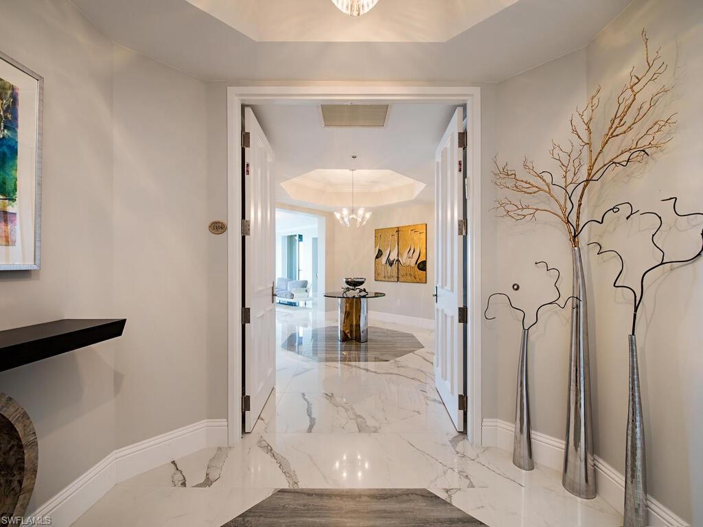 Rarely available 04 end unit at waterfront La Scala tower in The Colony Golf & Bay Club. Never miss a sunset in this South West facing 5,000+ SF interior/exterior space, 3 lanais 3 Bed + Den 3.5 bath sky home with breathtaking 180+ degree views.  Stepping off the elevator you are immersed with bright light colors and white porcelain floors throughout much of the unit. A large interior foyer provides an elegant central axis for the home. From there your attention will be quickly drawn to the enormous Great Room with walls of floor to ceiling windows and doors looking over Estero Bay and Gulf.  All rooms are generously sized and feature 9ft 8 in ceilings. A split plan has two guest rooms and expanded office on one side and the plush owners retreat with lanai access and spa sized marble bath on the other side. Many unique features abound and must be seen to be appreciated. La Scala owners enjoy two levels of amenities including: two story formal space, billiards room, theater, and library. The fitness center and pool/spa are luxury sized for only 64 owners. Feel secure with staffed front desk 24/7. Colony amenities: Bay Club dining, 34-acre island beach park and optional equity golf