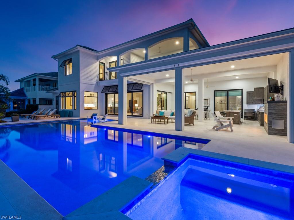 Exquisite WATER DIRECT home on .41 ac in the PRESTIGIOUS Tigertail area that offers captivating BAY VIEWS, SOUTHERN rear exp & QUICK OUT to the Gulf. Completed in 11/20, this home has been lightly lived in & is LIKE NEW. Enter through the CUSTOM MAHOGANY and GLASS doors into the OPEN SPLIT floor plan with BREATHTAKING views of the water beyond. The MASSIVE OUTDOOR area features a CHEF'S KITCHEN, a breakfast/cocktail bar island, a sparkling L-shaped POOL w/waterfall SPA & SUN SHELF, a gas FIREPLACE, an Outdoor Shower, a Pool Bath & ELECTRIC SCREENS/SHUTTERS. The Gourmet Kitchen features THERMADOR SS appliances, QUARTZ countertops, a farmhouse/apron sink & WALK-IN PANTRY.  On the 2nd floor, you'll find a relaxing ENTERTAINMENT area w/COVERED TERRACE and more amazing views of the bay! This home features 12' ceilings, WHITE OAK FLOORING, ELECTRIC BLINDS, 4-CAR GARAGE, IMPACT WINDOWS/DOORS, TANKLESS water heater, NEWER SEAWALL, wrap-around BOAT DOCK, WATER FILTRATION, GENERATOR, Custom Draperies, Custom Storage Shelves, DESIGNER-SELECTED FURNITURE & more! With its exceptional location & features, stunning views & proximity to the beach, this home offers a lifestyle beyond compare!