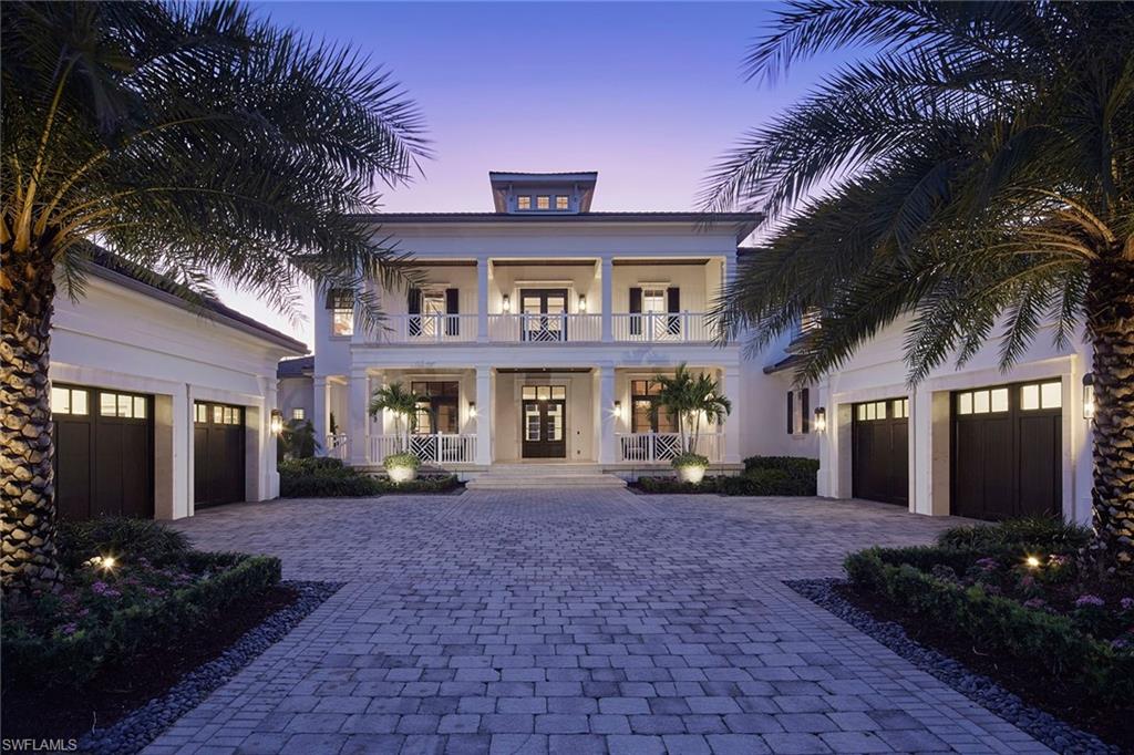 IMMEDIATE FULL GREY OAKS GOLF MEMBERSHIP AVAILABLE.  Welcome to this British West Indies–inspired custom estate, perfectly positioned on a picturesque 0.64-acre lake, golf, and preserve homesite within the prestigious Estuary at Grey Oaks. Handcrafted by London Bay Homes in 2011 and offered fully furnished with interiors by Romanza including Florida style artwork and custom made Kindel furniture throughout this exceptional residence spanning over 7,300 square feet of refined living space.  Upon entering the spacious foyer, you are greeted by an inviting living room featuring a gas fireplace and French doors that open to the outdoor living area and sweeping panoramic views beyond. The home showcases rich, engineered hickory wide-plank wood flooring throughout the main living areas, complemented by intricate ceiling details, exquisite custom millwork, and Pennville cabinetry by SOHO.  The chef’s kitchen is thoughtfully designed with a spacious mahogany-topped island, dual fuel Viking range, Sub-Zero refrigeration, and an adjacent dining area with a tongue-and-groove ceiling. A butler’s pantry and catering kitchen offer a wine cooler, icemaker, beverage drawers, and an additional dishwasher. Flowing seamlessly into the inviting family room, the space is highlighted by a vaulted beam ceiling and 90-degree pocketing sliders that frame tranquil views of the lake and the lush 11th hole of the Estuary golf course.  Outdoor living is equally impressive and ideal for both entertaining and enjoying Naples’ renowned winter climate. The expansive covered living area features a cypress wood ceiling with separate dining and sitting areas divided by a double-sided fireplace. The outdoor living space also includes a fully equipped outdoor kitchen with Viking gas grill and sink, all enclosed with automated screens and shutters. The resort-style pool area showcases a glass-tiled water feature, heated gas pool, and elevated spa with cascading spillover.  The expansive first-floor primary suite has picturesque views of the lake, golf course, and preserve and includes a separate sitting area, dual marble-adorned baths and custom closets.  A private, wood-paneled library is ideally situated near the primary suite and features two sets of French doors that open to the covered veranda.  Additional highlights include: four climate-controlled garage spaces with epoxy flooring, hurricane impact–rated windows and doors throughout, a 48kW natural gas generator, extensive landscape lighting, guest beds are all ensuite, recently enhanced landscaping, newer HVAC systems, Lutron lighting system, security system with one-touch exterior security lighting, a second-floor lounge with a unique vaulted cupola ceiling, wet bar and under-counter refrigerator.  Residents of Grey Oaks Country Club enjoy an unparalleled lifestyle with three 18-hole championship golf courses and world-class amenities, all just minutes from downtown Naples’ premier shopping, dining, and beaches.