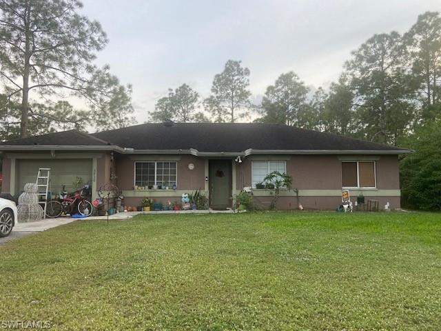 A must see.  Four Bedroom, two bath house on a spacious 1.17 Lot. Lots of trees. The house features tile throughout.  Live your Naples dream on more than an acre of land.