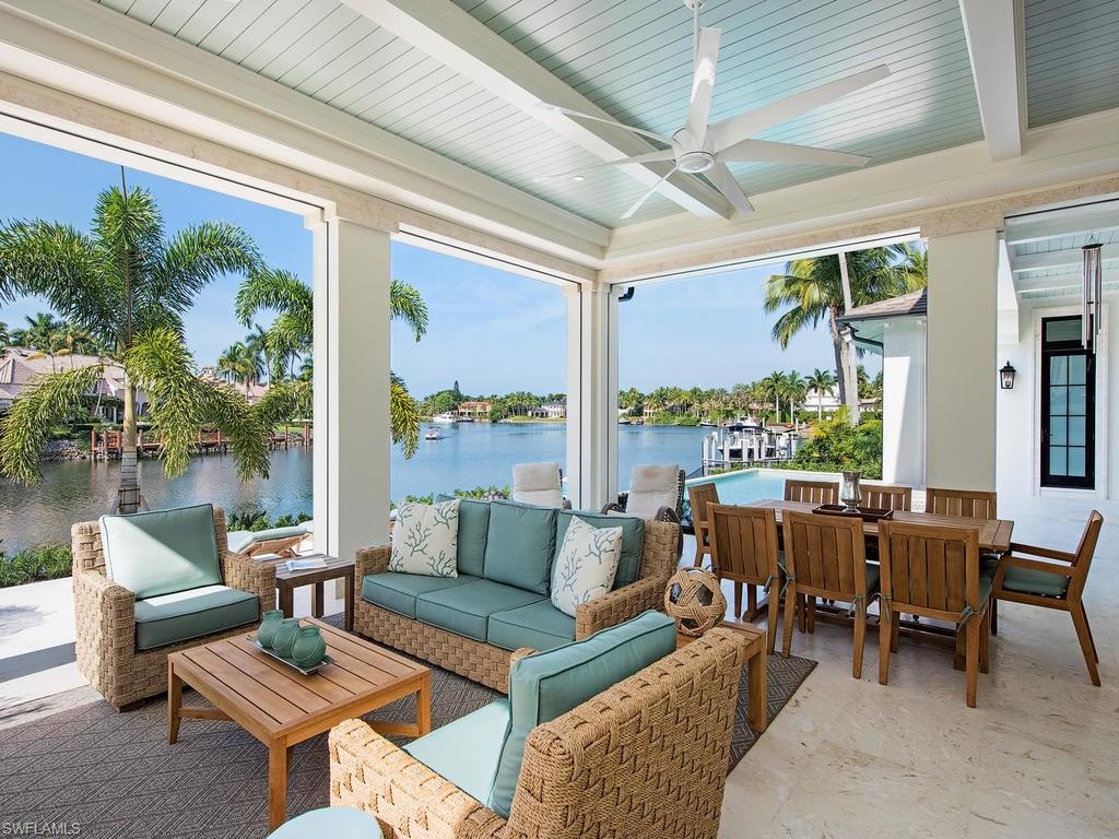 Enjoy the Port Royal Lifestyle. This beautiful custom home was completed in 2016 with 120 ft of water frontage. Constructed by The Williams Group, this timeless home designed by Stofft Cooney boasts one of the longest views of Morgan's Cove and is just a short walk to the Port Royal Club and the sugar sand beaches of the Gulf of Mexico.  No detail was overlooked.  The entry foyer with it's grand staircase, substantial millwork and 24 ft. nickel groove ceiling leads you to the large Great Room with custom built-in's. The approximately 2500 sq ft. of  outdoor living space includes infinity spa, large pool, outdoor living room with fireplace and kitchen.  The stunning white on white chefs kitchen offers state of the art appliances, (including a 60 inch Viking range) a wall of windows and white honed marble countertops. Outside of the kitchen is a butler pantry and bar which is adjacent to an elegant dining room perfect for entertaining, including a custom wine room which will accommodate 1000 bottles of wine. There are 11 ft. ceilings throughout much of the home.  Custom doors lead to both upper and lower expansive living spaces.  Offered decorator furnished.