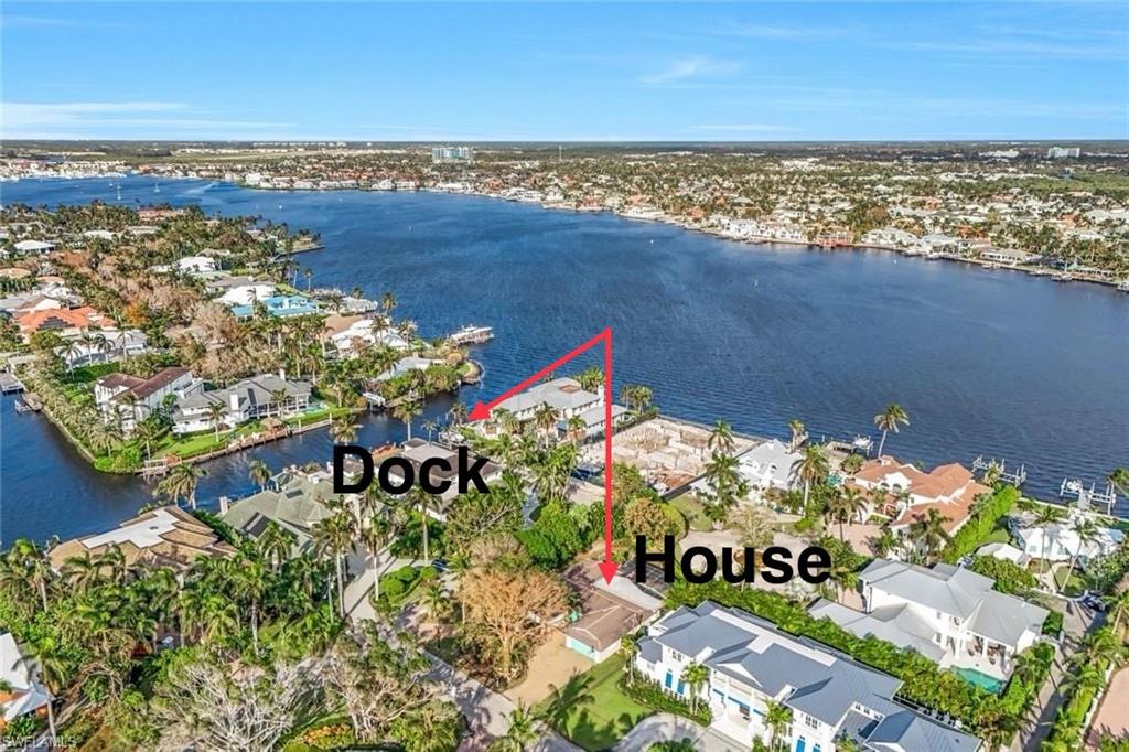 The LOWEST priced home in the Aqualane Shores neighborhood (by nearly 2 million dollars) creates a unique buying opportunity in today’s market. 2125 Marina Drive is situated in the sought after boating community of Aqualane Shores in the City of Naples.  This unique home sits on a 0.35 acre homesite, one house away from Naples Bay and it comes with a deeded boat dock just across the street at the end of 21st Ct S.  (Note that the homesite is not waterfront, but the included deeded dock steps away from the homesite is waterfront and provides easy, no bridge access to the Gulf of Mexico). Make sure to check out the video tour to see this home's prime location.  You will be surrounded by multimillion dollar estate homes, as the majority of Aqualane Shores has already been redeveloped.  Beautiful mature landscaping, including two producing mango trees and a lychee tree, adds a tranquil quality to this special property.  The house has 3 bedrooms, 3 full baths, an office, a 2 car garage and a swimming pool.  The home sustained about a foot of water damage to the structure and is being sold “as is” for lot value. However, a subsequent owner could likely restore the existing home if desired.  From this premier location, you are just a short stroll to beach access and downtown, the famous Naples Pier, fine dining establishments, world-class galleries & shopping and a bustling local farmer's market on fabulous Third Street South. Additional shopping and dining on 5th Avenue are just a short drive away. The current owner advises that the deeded boat dock can accommodate a 30ft boat with direct deep water access to Naples Bay and the Gulf of Mexico. The dock is located just steps from the residence and has a lift, water and electric at the dock.