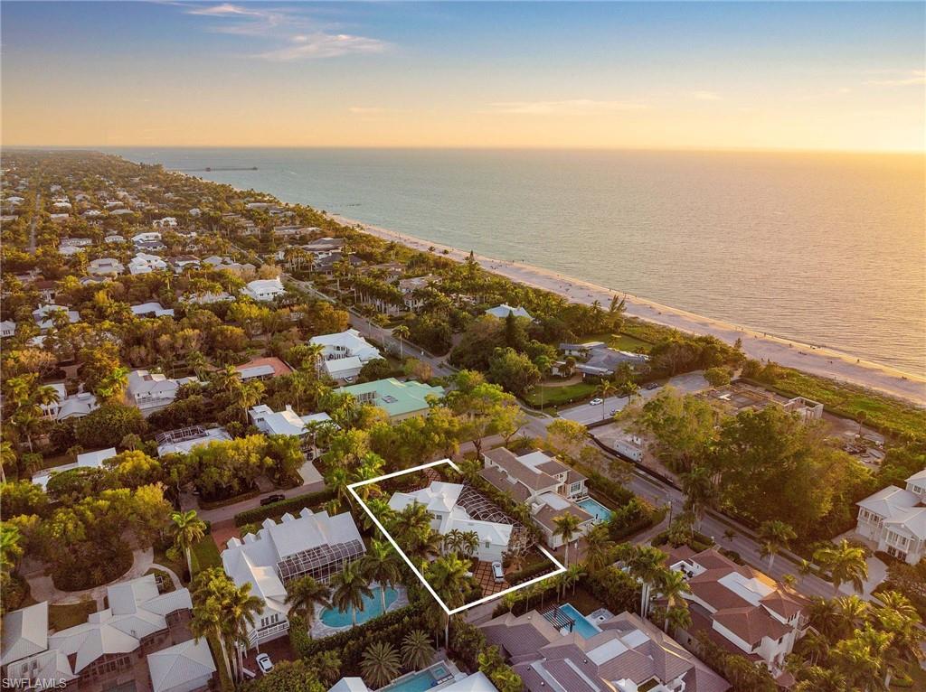 Located on one of the most beautiful streets in Old Naples, 3rd Avenue North, this captivating residence, on a wonderful lot just three houses from the beach, is a rare opportunity. This enchanting home flows gracefully from one engaging space to another. Multiple sitting and socializing areas including a formal living room that overlooks a spacious lanai with inviting pool and spa, which is perfect for entertaining. The first-floor master suite offers a walk-in closet, spa-like shower, dual vanities and an impressive view of the pool. Two additional guest bedrooms with dedicated en-suite baths provide comfortable, private space for guests. The second level features a large study, currently used as a fourth bedroom, and a separate oversized flex room. Lush tropical landscaping and many updates throughout. Conveniently located just minutes from 5th Avenue South and Third Street South, this home is a MUST SEE!
