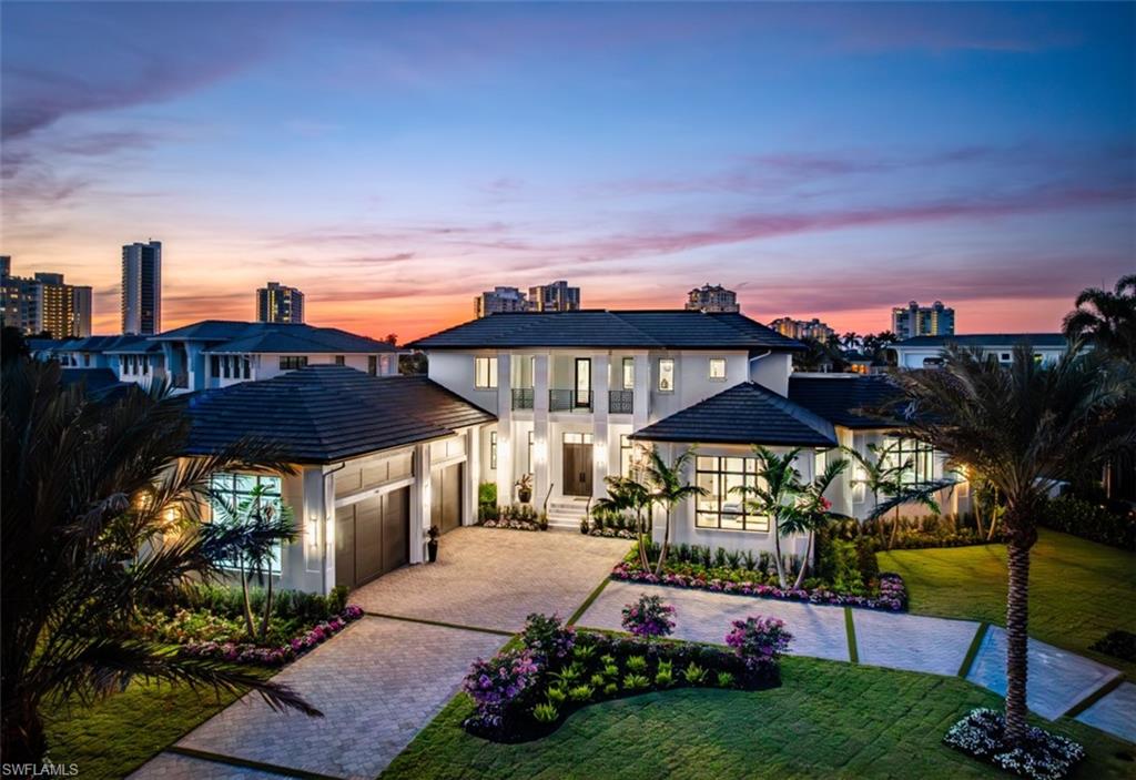 Indulge in the pinnacle of coastal luxury with this spectacular new-construction estate, perfectly positioned on the shimmering bay in prestigious Park Shore. Masterfully crafted to evoke the ambiance of a world-class resort, this breathtaking residence blends architectural excellence with sweeping white-water views, creating an unmatched living experience in one of Naples’ most coveted waterfront enclaves. From the moment you enter, walls of glass draw your eye directly to the bay. Every room is thoughtfully designed to blur the line between indoors and out, capturing the essence of elevated Florida living at its finest. The primary suite is a sanctuary of indulgence—an expansive retreat featuring a tranquil sitting area and spa like bath offers a true rejuvenation experience with multiple showerheads, exquisite stonework, and custom cabinetry that showcases both craftsmanship and elegance. Massive walk-in closets with beautifully executed built-ins provide unparalleled storage and display. The culinary spaces are equally extraordinary. Anchored by a professional gas range and multiple ovens, the showstopping chef’s kitchen is complemented by a full butler’s kitchen, walk-in pantry, beverage center, and an elite suite of top-tier appliances. Multiple dining areas—both formal and casual—flow seamlessly into sophisticated gathering spaces enhanced by custom fireplaces, designer lighting, soaring ceilings, and impeccable architectural detail. The outdoor living experience rivals the world’s finest resorts. Vast, covered terraces overlook the wide bay, inviting you to unwind in multiple lounge and conversation areas. The outdoor kitchen is fully equipped for open-air entertaining, while the resort-style pool—framed by panoramic water views—creates a dramatic focal point that transforms each sunset into a private show. A private elevator, four-car garage, loft area, executive office, and beautifully appointed guest suites complete this one-of-a-kind offering. Every finish has been curated with precision, every detail executed to perfection, and every space designed to elevate your lifestyle. This is more than a home—it is a statement of luxury, craftsmanship, and refined waterfront living, delivering the ultimate resort-style experience in the heart of Park Shore. Brought to you by Knauf Koenig Builders, Falcon Design Inc. and Clive Daniel Homes.
