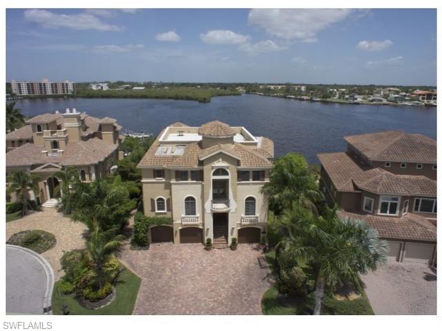 Dramatic wide bay views highlight this palatial waterfront estate. Just steps to the beach, in the gated enclave of Southport on the Bay, within Barefoot Beach. The open floor plan is accentuated by sliding pocketing window walls from the kitchen and great room- opening the living areas to the most panoramic bay views.  Other outdoor features include: Logia with fireplace, summer kitchen, infinity edge pool and spa, insect mist system and large sundeck.  Construction features concrete block, with impact resistant doors and windows. Room for all the toys with 3 plus garage spaces, large dock with 2 boat lifts and wave runner dockage.  The interior boasts 7365 of A/C space. The master bedroom is spacious and open with sliding pocket doors, with an additional 5 bedroom suites, recreation room and fitness area enhance entertaining for any size family.  Other features include: elevator, marble flooring, venetian plaster walls, volume coffered ceilings with recessed lighting. Barefoot Beach is located in the NW Corner of Collier Country, the perfect location.