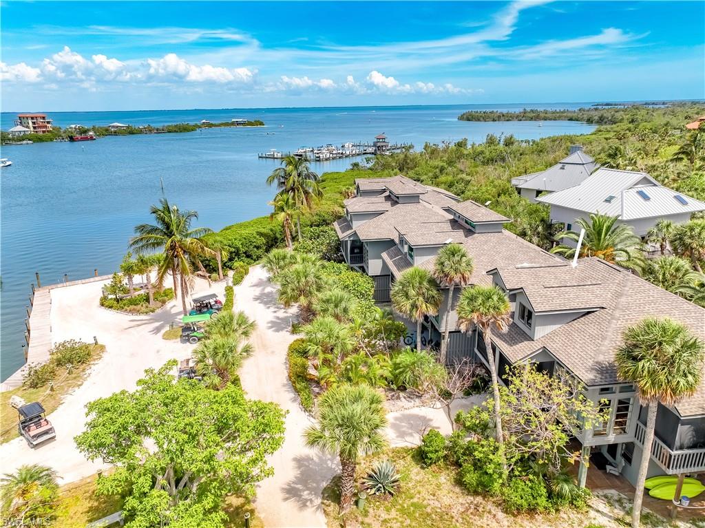 Wake Up in Paradise at Sunrise Bay on North Captiva Island! Picture this: the first light of dawn glistens across Pine Island Sound as you sip coffee on your screened porch, watching the world wake up in perfect peace. A gentle sea breeze slips through palm fronds, and within minutes, you can be out the door and onto your docked boat, sandy Gulf shoreline, or quiet nature trail. Sunrise Bay isn't just a townhome - it's your front-row seat to island life. This 3-bedroom, 2-bath townhome has been stylishly updated to deliver modern coastal comfort with a dose of Old Florida charm. Inside, sunlit living spaces, tasteful furnishings, and thoughtful upgrades create a warm, effortless retreat. The townhouse is entirely turnkey, with thoughtfully updated décor and furnishings so you can settle in and start enjoying your new island retreat immediately. Outside, you're just a short hop to the ferry landing, Dock Slips, Over the Waterfront Dining, and endless opportunities to fish, shell, kayak, or relax in total tranquility. For boaters, this property is a dream come true, with community docks that provide easy access to the Gulf for fishing trips, sunset cruises, or island-hopping adventures. If you prefer to keep your toes in the sand, pristine Gulf-side beaches are just a short golf cart ride away, making spontaneous beach visits part of your everyday life. Safety Harbor Club's included resort-style amenities, including the recently updated sparkling heated community pool, tennis & pickleball courts, a clubhouse, and waterfront dining, give you the best of vacation living right at home. Perfect for a personal island hideaway or an income-generating rental, Sunrise Bay blends laid-back luxury with unbeatable convenience. Properties with this level of charm, boat dockage, & water views don't usually last long at this price.  Schedule a showing today and claim your place in paradise!