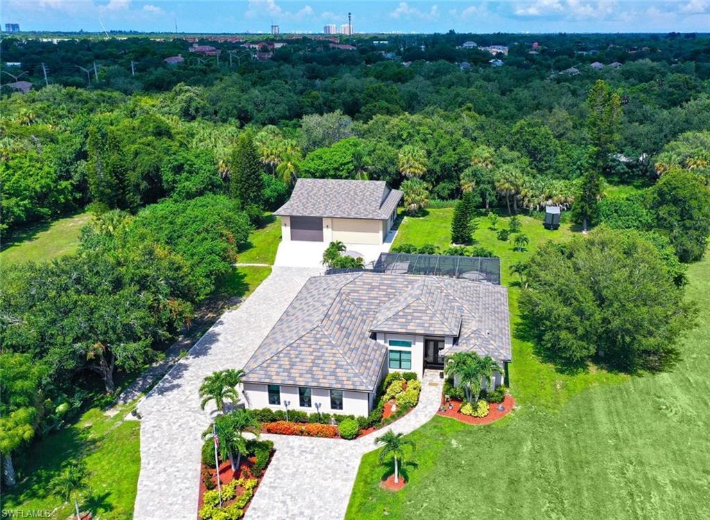An amazing opportunity to own a newer construction ranch style home, with NO hoa, an acre of land and a car enthusiasts dream! Let's start with the $27,000 brick paved driveway, that leads to the front entrance that is welcoming and ready to embrace family and friends. Upon entry you will look through the living area to the outdoor space thats is equally inviting. A private home office, sits at the front of the home, the primary suite, is immediate to the right, with an over size bathroom and dual walk in closets. The bedroom offers access to the screened pool area along with beautiful landscaped views. While the living area, is all encompassing, for entertaining, its grand area says come on in and stay for a while, with it coffered high vaulted ceilings and the grand space wondering if your here for dinner or just some great food, because the dual island allows for everyone to participate.  The formal dining area fits a family environment! GE monogram series appliances, beautiful marble counter tops and an elegant and modern backsplash. Shaker style cabinets grant you lots of space for culinary ware. 2 ensuite, split floor plan, offer family or guests their own privacy, with one ensuite sharing its space with a pool bath. Going outside, to the stunning brick paved driveway, with a 3 car attached garage with windows and of course storage. For those car enthusiasts... the driveway continues to the back of the property where a concrete block detached garage.. with 2300 sq ft 14 ft ceilings and offers enough room for multiple cars: A lift, an exhaust fan, storage shelves and an extra space where perhaps wood working or crafts can be done, out of the elements yet not in the auto garage. multiple hurricane shutters: 2 outter are 12” with 1  10”  that protect and create space for the boys with the toys. This home comes with a "whole home" generator, is on a well and septic with a full reverse osmosis system. No hoa.. did we mention that? No Flood Insurance required. Easy drive to medical, grocery, shoping, dining and your closest beach, is Bonita Beach. Come See See us soon.
its location to coconut point 2.6 miles, bonita promenade 6.5 miles and about 6.7 miles to Mercato.. great location!