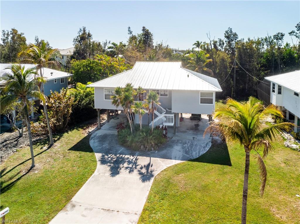 Captains Cove,  2- bedrooms 2.5- baths, Piling Home and pool at the North end Of Pine Island...  Great location Private Boat Ramp, Close to Charlotte Harbor, some of the best fishing and boating anywhere,,, and the 16 mile Bike path. Marinas and Restaurants are walking distance. Cute Piling home with carports, shop & storage, pool with wood fence and a nice 75'x125' lot. Great house for couple, Seasonal or rental... Visit Pine Island and See this tropical home in the sky, Today !!