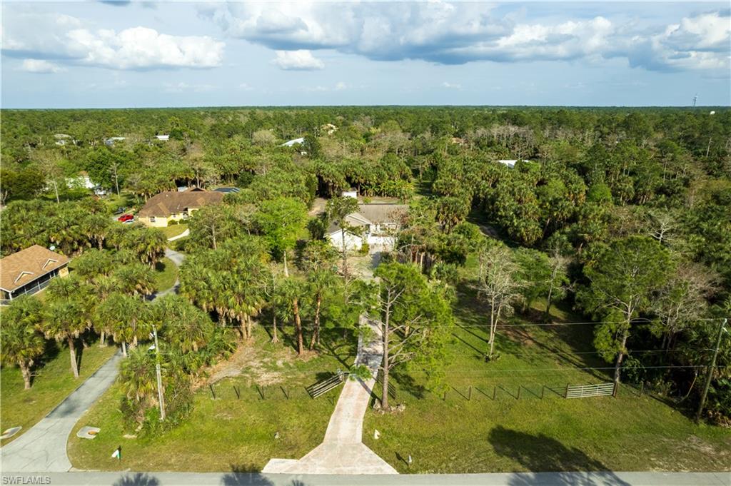 This 3-bedroom, 2.5-bathroom home in Golden Gate Estates is nestled on a sprawling 2.5-acre parcel, offering a canvas for your imagination to flourish. Step into the spacious interior, where endless possibilities await. This split floor plan home has three bedrooms and Impact windows and doors throughout providing comfort and privacy. The open kitchen features propane cooking and a slide window for outdoor entertaining. Outside, discover your own oasis with a pool which invites you to relax and unwind, surrounded by the lush greenery of your own private retreat just minutes to Collier Blvd and 12 miles to the beach. Enjoy the perfect blend of indoor and outdoor living with a screened-in lanai, providing a seamless transition between the comforts of home and the beauty of nature. Blooming landscaping and fruit trees provide a great foundation on the 2.5 acres with potential for expansion, landscaping, or creating the ultimate outdoor escape is yours to explore. The gated entrance leads to a large circular driveway and oversized 2 car garage which allows for plenty of parking. Don't miss this chance to craft the home that you've always envisioned in the heart of Naples’s Golden Gate Estates. Bring your vision and make it your own.