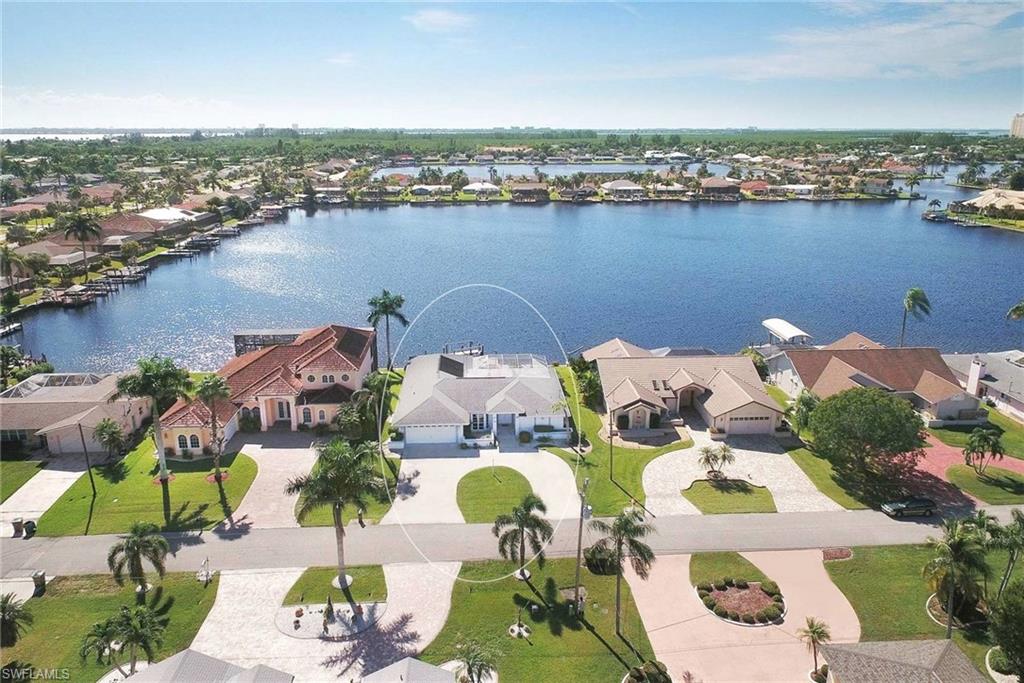 BOAT LOVER'S DREAM! Enjoy the beauty of superb water views as well as quick boating access to the Gulf of Mexico. This spacious 3/2 single family home boasts tranquil views, southern exposure and a screened-in lanai that is the perfect space for entertaining while enjoying the Florida sunshine! The property offers the convenience of a backyard boat dock with a 10,000 lb lift and features a wrap-around Terex deck which allows someone to walk on both sides while the boat is in the lift. Don't miss out on this pool home situated in the Eight Lakes neighborhood of Cape Coral. Make it your own!