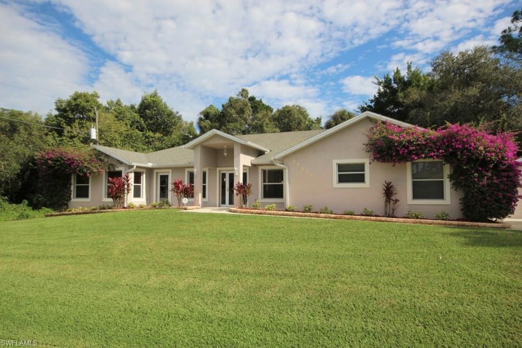 Reduced for quick sale, situated in almost a half-acre of quiet, woodland of Bonita Springs, & just 3.8 miles from the beautiful Gulf beaches, this spacious 3-bed/2-bath home has significant upgrades.  Enjoy the tiled Great Room with its cathedral ceiling and open floor plan.  The high ceiling with remote-controlled lighting and ceiling fans ensure cool air at an economical price. All three bedrooms have bamboo floors and the bathrooms are fully tiled.  The master bath has a large soaking tub and spa-like showers.  The large walk-in closet is finished in custom dark wood cabinetry.  The other 2 bedrooms can be cordoned off to form a guest suite. The hallway has a fully equipped laundry with fitted cabinets and work tops.  The kitchen has a large functional island, granite counter-tops, customized cabinets with split-level ovens and microwave as well as other modern appliances. Step out on the large screened patio with views of the creek that feeds into the Imperial River, or out onto the wooden deck for relaxation.  The paved driveway leads up to a large 2-car garage.  The monitored security system offers extra protection.  This beautiful home is excellent value for money.