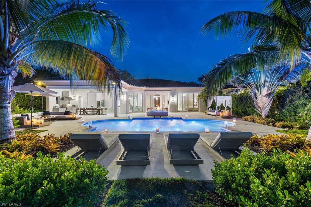 This extraordinary residence is completely renovated and has IMMEDIATE golf membership in Grey Oaks. Imagine entering a home that has everything completed, furnished in the highest quality furnishings, and spectacular golf course and lake vistas…with a large backyard for your dog and kids/grandkids!  Completely re-imagined with wide-plank, white oak wood flooring throughout, all archways have been squared off, Chef's gourmet kitchen with high-end appliances, all new bathrooms, new LED fixtures, and designed with impeccable taste. Roof & windows? Fret no more, as this residence has a new roof, as well as impact windows and doors. This home is perfect for entertaining, with a large, new lanai and pool, outdoor kitchen with automated screens…and how good will those s'mores taste around the fire pit? From the moment you enter, you will be mesmerized by the spectacular views, expansive pool and fenced garden, drawing you outside. Golfers will relish the views of the 5th hole on the Palms Course.  Truly, you have found a jewel with this home, which is located in a club that has the finest amenities available, yet only minutes from all that Naples has to offer. Welcome home...
