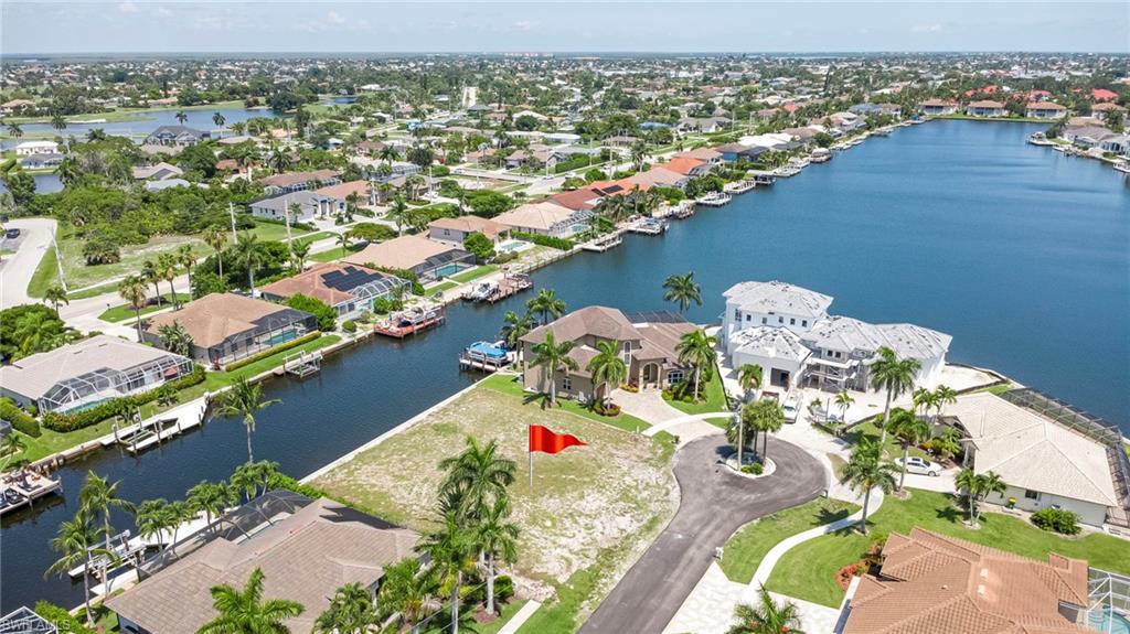 A rare opportunity to create a signature waterfront estate on Marco Island. Positioned on an oversized, .28 acre, cul-de-sac homesite with 120 feet of waterfrontage (concrete seawall in place), 375 Wales Court offers the perfect canvas for an exceptional custom residence. Framed by sparkling waterways and surrounded by luxury homes, this premier lot captures the essence of the Marco Island lifestyle, boating, sunshine, and breathtaking water views. From sunrise coffee overlooking the water to sunset cruises from your backyard dock, the refreshing salt water air will fill your days. With Gulf access and wide canal views, every day begins and ends on the water. Located just minutes from Marco Island's renowned beaches, fine dining, boutique shopping, golf courses, and marinas, this is more than a homesite, it's an opportunity to build a legacy waterfront residence in one of Southwest Florida's most prestigious island communities.