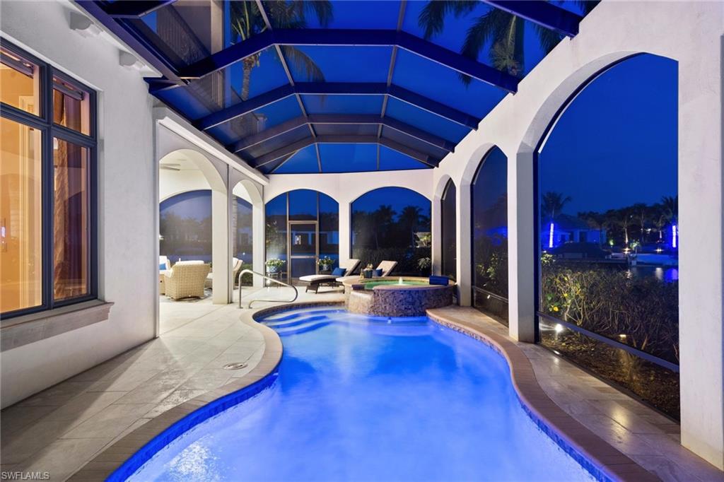 One or more photo(s) has been virtually staged, AI generated or rendered.  One or more photo(s) has been virtually staged, AI generated or rendered. Experience elevated waterfront living in this spectacular corner-lot residence in Costa Amalfi at Miromar Lakes. Showcasing stunning wrap-around views of the lake and sandy beach, this home is perfectly positioned to capture breathtaking sunsets with its coveted southwest exposure. The spacious floor plan features a luxurious first-floor primary suite, an open-concept kitchen and living area with high-end finishes, a sophisticated wet bar, and a private guest suite with en-suite bath. Upstairs, accessible by elevator, you’ll find two additional en-suite bedrooms, a versatile loft, and an expansive balcony overlooking the water. Designed for both comfort and entertaining, this home offers the best of indoor-outdoor Florida living. Located within the award-winning Miromar Lakes Beach & Golf Club, residents enjoy 700 acres of freshwater lakes, a 10,000-square-foot zero-entry infinity pool, three miles of private white-sand beach, boating, tennis, pickleball, spa, fitness center, and waterfront dining. A rare opportunity to own a stunning piece of paradise in one of Southwest Florida’s most sought-after luxury communities.