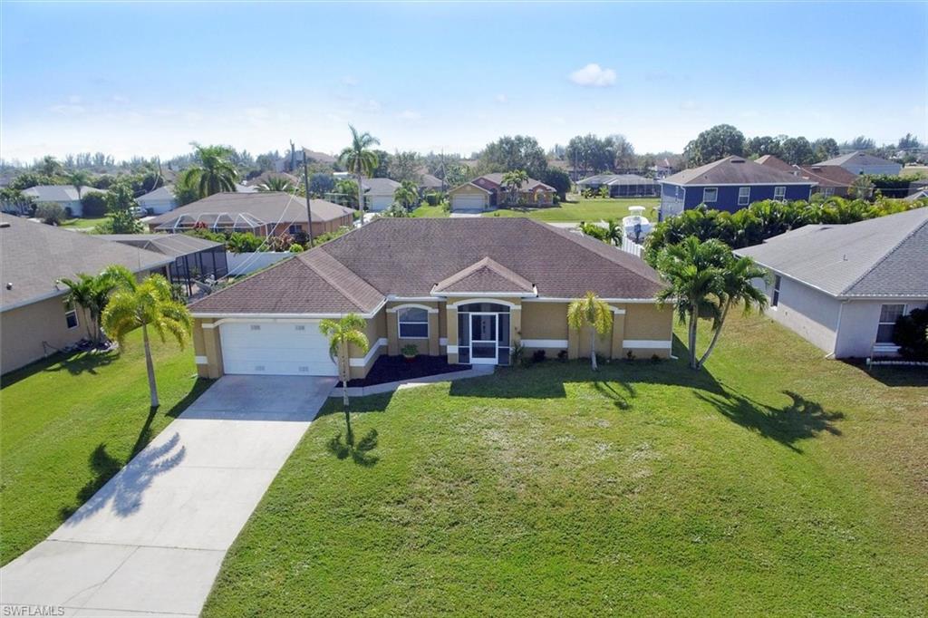 You are going to love this very well designed pool home located in a very convenient part of Cape Coral that is close to everything! Directly across the street from Patriot Elementary school which is excellent if you have younger kids saving lots of commute time to and from school. You will love the open floor plan with split bedrooms, French door entry with decorative etched glass doors, a large eat in kitchen dining area and a eat in bar. Updated tile wall under the bar with stiletto accents. SS appliances included. The rear of the home faces the South which is perfect to get the most sun into your pool. There is a large lanai under truss as well as lots of pool deck space to catch some Florida sun. The home has auto sprinklers for the lawn which are run off a well. All the bedrooms have walk in closets. The laundry is inside just off the kitchen with lots of room for additional storage shelving. The den is in a great location on the front of the home which would make a perfect home office! The home has a hip roof with 3d shingles which should save you money on your homeowners insurance. Highest and best delivered by Wednesday 12:00pm noon 12/15/2021
