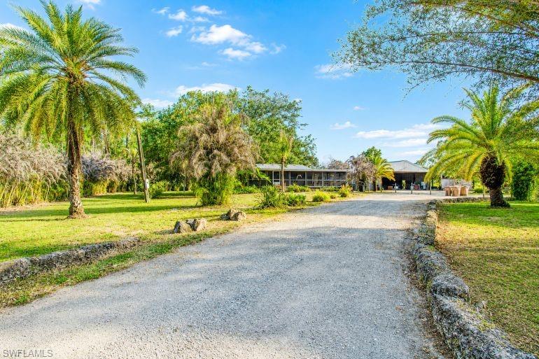 Discover the rare opportunity to own 10 beautiful acres in the covered Alva area of East Lee County, where Old Florida charm meets endless potential. Tucked away at the end of Packinghouse Road, this private and secluded property offers a breathtaking park-like setting adorned with majestic live oak trees, lush tropical vegetation, and a peaceful pond that enhances the natural beauty of the land. 

The property is fully fenced and improved with a pole barn featuring an efficiency apartment, offering immediate usability and excellent potential to convert into a stylish barndominium, guest quarters, or workshop/living space. Also located on the property is an older double-wide mobile home, ideal as temporary residence while you build your dream estate, family compound, or country retreat. 

Perfectly positioned just off Florida State Road 80 and near Alva Diner, this location combines the tranquility of country living with convenient access to shopping, dining, and Southwest Florida amenities. 

Highly desirable Alva is known for its spacious estates, scenic beauty, and relaxed rural lifestyle-making this property a true gem for those seeking room to room, privacy, and unlimited possibilities. 

Bring your horses, toys, and vision-this is the Alva acreage you've been waiting for.