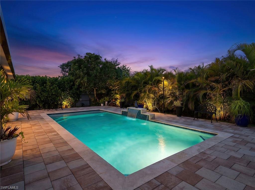Don't miss this stunning 3-bedroom, 2-bath, 2-car garage home featuring a split floor plan, major updates throughout, and a custom resort-style saltwater pool — all meticulously maintained and move-in ready bounous no flood insurance needed. The showstopper is the 2022 saltwater pool, designed for entertaining and family fun, surrounded by professional landscaping and a private fenced backyard. The home faces west, so you'll enjoy breathtaking sunsets from your expansive covered lanai. A second covered lanai (52x16) was added in 2023, significantly extending your outdoor living space. The kitchen was fully updated in 2021 with granite countertops, a stylish backsplash, and all-new appliances — perfect for the home chef. Both bathrooms have been tastefully updated. The roof was replaced in 2022, giving buyers years of worry-free ownership. Additional peace-of-mind features include a reverse osmosis system in the kitchen and a whole-home water filtration system (2022). The lush yard is a true tropical paradise with your own fruit grove: mango, lime, mandarin, avocado, papaya, and guava trees. An automatic sprinkler system keeps the front and back yards green year-round.