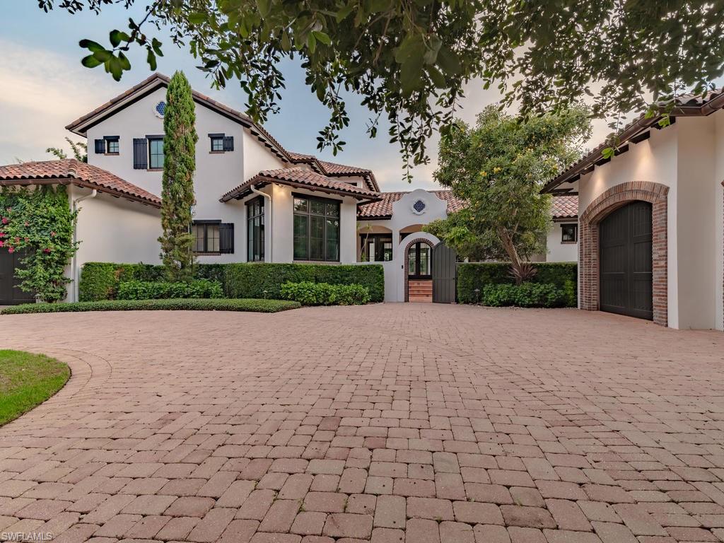 This Spanish Revival masterpiece is situated on a double lot on cul de sac in the Moorings, 1 mile from the beach & 2 miles to Venetian Village/5th Ave restaurant district! A one-of-a-kind Spanish/Moorish inspired courtyard residence showcasing intricate tile, opulent marble/granite, richly stained wood and masterfully choreographed custom lighting, creating an ambiance of understated luxury. Discover graceful arcades, French doors, abundant windows and 13’ gallery halls in 8,000 SF of snowy stucco walls blurring the lines between interior/exterior spaces. Step through the arched entryway garden to the front doors and be captivated by the main gallery and views of the central courtyard with impressive quatrefoil shaped fountain. The gourmet kitchen is open to the dining area and step-down brick-clad bar and great room, separated by the brick archway leading to the expansive screened-in outdoor living. 5 oversized bedrooms with large walk-in closets, 4 full baths, powder room, pool bath, media room, study, a multipurpose laundry room, home automation system, 3-car garage, custom Moorish& Spanish fountains, resort-style pool/spa and built in fire-pit complete this magnificent home.