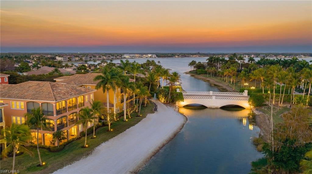 Welcome to this beautifully positioned first-floor Vivaldi residence in Miromar Lakes Beach & Golf Club, offering effortless lakefront living with desirable southern exposure and sweeping long lake views. Bathed in natural light throughout the day, this two-bedroom plus den condominium captures stunning sunsets and invites you to enjoy peaceful evening walks along the beach just steps from your door.

The thoughtfully designed floor plan offers an open and inviting layout, ideal for both everyday living and entertaining. The spacious kitchen flows seamlessly into the living and dining areas, all oriented toward the water views. A versatile den provides the perfect space for a home office, media room, or additional guest accommodations.

One of the most special features of this residence is the expansive wraparound lanai, complete with hurricane shutters for peace of mind and an outdoor kitchen that makes alfresco dining and sunset gatherings effortless. Whether hosting friends or enjoying a quiet morning coffee, the outdoor living space truly extends the home.

Located directly across from the Vivaldi community pool, you’ll enjoy the convenience of resort-style relaxation just steps away, while still savoring the privacy of your own lakeside retreat.

Beyond your front door, the award-winning community offers an extraordinary array of amenities designed to elevate everyday living. Residents enjoy a private white sand beach stretching along 700 acres of freshwater lakes, a full-service marina, boating, paddleboarding, and kayaking. The elegant clubhouse features waterfront dining, indoor and outdoor bars, and a vibrant social calendar filled with events and activities. Fitness enthusiasts appreciate the state-of-the-art fitness center, full-service spa, Har-Tru tennis courts, pickleball, and bocce. The championship golf course provides an exceptional experience for players of all levels, while scenic walking and biking paths wind throughout the community.

With beach access nearby, panoramic water views, and world-class amenities at your fingertips, this Vivaldi residence offers the perfect blend of luxury, leisure, and the effortless coastal lifestyle that makes Miromar Lakes so special.