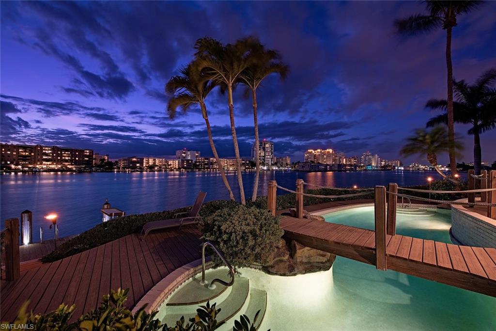 H.15796 - Spectacular western exposure, on an oversized, property  at the end of Bahia Point cul-de-sac, with approximately 170' of frontage and a large boat house. Imagine swimming in your pool with an expansive 180 degree view of Moorings Bay, spanning from Venetian Village to the North to Harbour Bridge to the south. Relax in your classic Florida home and your back yard while watching mullet jump, dolphins play, and birds fly overhead from one of the best bay-front sites in all of Naples, especially for morning and evening skylines, boating and sunsets. At the tip of the point, this property is the pinnacle of the  Moorings and Park Shore waterfront.  Residents are eligible for membership in the private and peaceful Moorings Beach Park.  Owned by the same family for a quarter of a century, this is a once in a lifetime opportunity that will allow you to live the Florida lifestyle on one of the most desired properties in the Moorings.