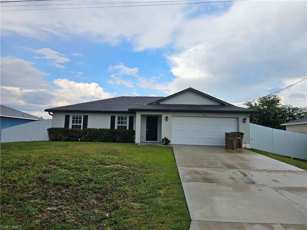 Built in 2023, this beautiful home is fully fenced and features ceramic tile flooring throughout, offering privacy, style, and easy maintenance. Its modern open-concept layout seamlessly connects the living room, dining area, and kitchen, creating a spacious main living area perfect for everyday living and entertaining. Sliding glass doors lead to a covered lanai with a ceiling fan, providing the ideal space to relax outdoors.

The living room features a vaulted ceiling, while the kitchen boasts a stylish center island with a breakfast bar, modern cabinetry, and stainless steel appliances, including a range, microwave, and dishwasher.

The private owner's suite is thoughtfully separated from the secondary bedrooms and includes a spacious walk-in closet and an en-suite bathroom with a dual-sink vanity, walk-in shower, and private water closet. On the opposite side of the home, you'll find two additional bedrooms and a full bathroom, perfect for family members or guests.

Additional features include a two-car attached garage, hurricane-impact windows and doors, and well maintenance is included and covered by the owner.