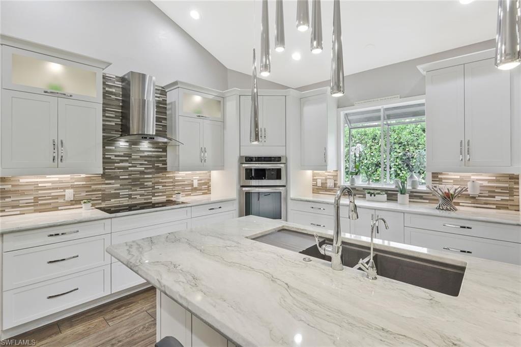 Reduced to sell!!!  Perfectly positioned on a much sought after  cul-de-sac in the heart of Pelican Bay on a .36 acre lot, this one of a kind this iconic residence has been masterfully updated and offers the ideal blend of luxury, comfort, and location. Just moments from Artis-Naples, Southwest Florida’s premier performing arts center, Dramatic features the home features soaring ceilings and an impressive loft overlooking the main living area anchored by a cozy fireplace. The stunning updated kitchen showcases elegant Sea Pearl quartzite countertops, quality cabinetry, and generous prep space, while updated guest bathrooms add a fresh, modern feel throughout.
Step outside to your private tropical retreat where a sparkling pool and spa are complemented by a fully equipped outdoor kitchen, expansive entertaining areas, and a beautiful pergola with a fire feature, creating the perfect setting for gatherings year-round. A large wet bar further enhances the home’s entertaining appeal.
Additional highlights include hurricane protection throughout, abundant natural light, and a floor plan designed to maximize both privacy and functionality.Located in one of Naples’ most sought-after communities, residents of Pelican Bay enjoy private beach access, beachfront dining, tennis, fitness, and miles of scenic walking paths. This is a rare opportunity to own a move-in ready home in a truly second-to-none location. Pelican Bay golf course. Pelican Bay residents enjoy 18 tennis courts, 20 pickleball courts, a community center offering exercise classes, private fitness trainers  Pelican  Just minutes to Whole Foods, Trader Joes, Mercato, two movie theaters and shopping. Owners and guests enjoy  complimentary kayaks, sea kayaks, canoes and paddle boards all part of the Pelican Bay package. Pelican Bay  has its own Publix, Ace Hardware, CVS, charming restaurants and shops. Topping off  these amenities are two private beach clubs offering two casual dining restaurants, beach attendants and morning exercise classes . World class entertainment awaits you at Artis-Naples, At Waterside Shops you will find fun dining and shopping at Saks Firth Ave, Apple Store, Tiffany, Hermes, and coming to Waterside Shops a new Restoration Hardware concept. See the video to get the full effect of the units unqiue qualities. BE SURE TO VIEW VIDEO ON THIS LISING!